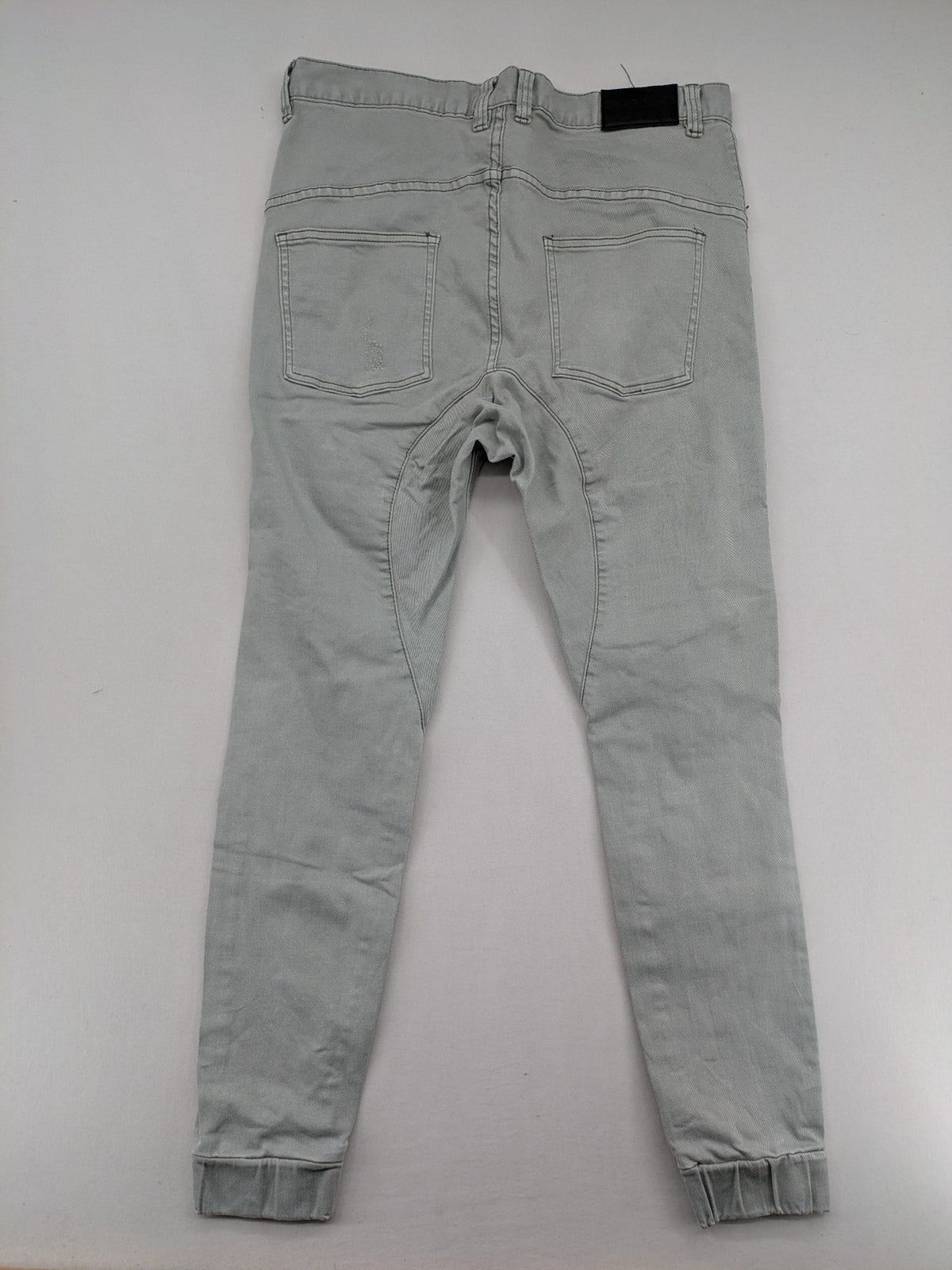 KSCY grey straight jeans with distressed details and ribbed biker inserts.
