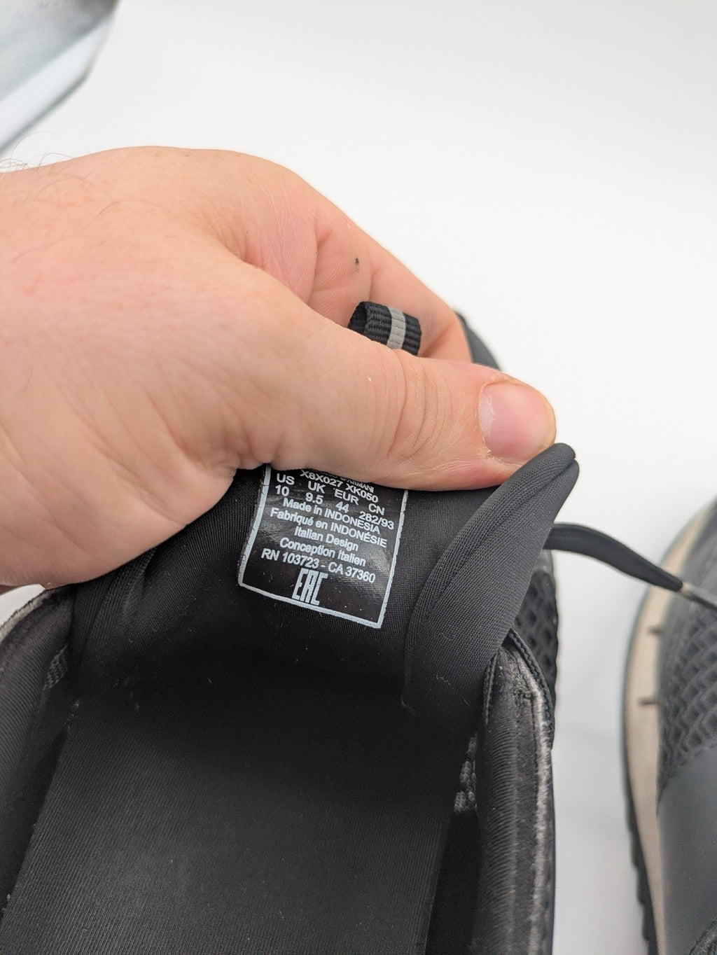 EA7 Emporio Armani beige and black sneakers with prominent EA7 branding and breathable mesh details.