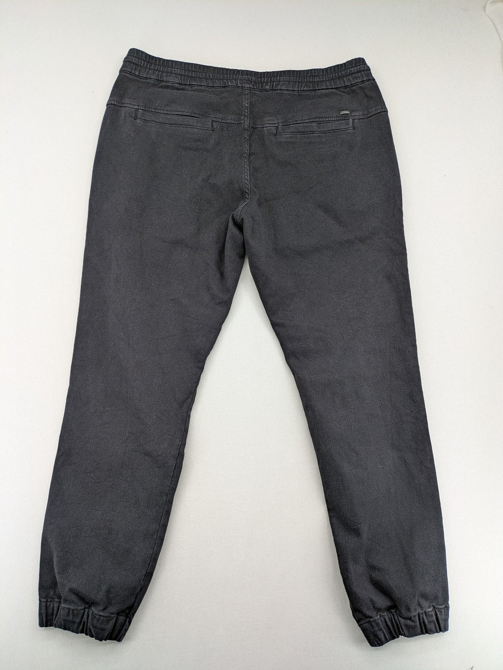 C&A grey jogger pants with elastic cuffs, drawstring waist, and multiple pockets.