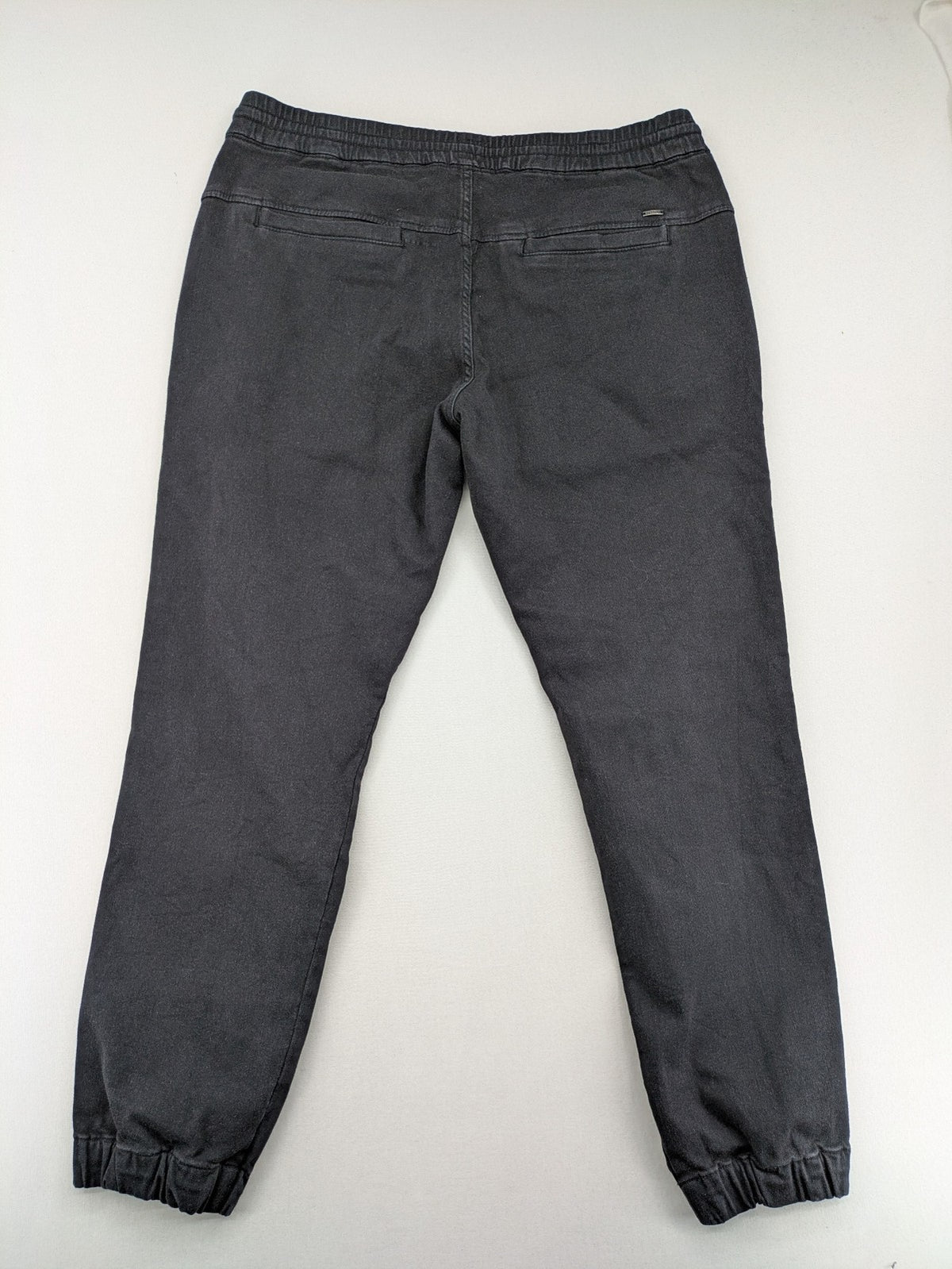 C&A grey jogger pants with elastic cuffs, drawstring waist, and multiple pockets.