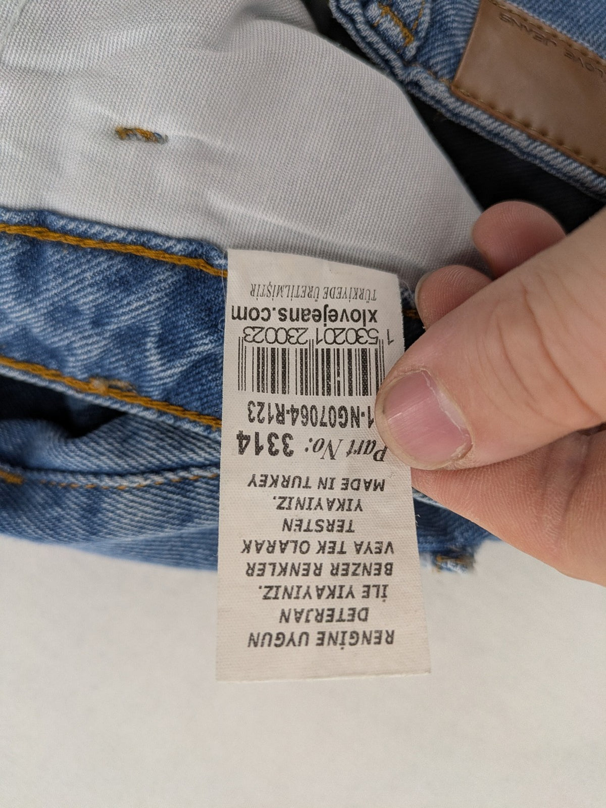 X.LOVE blue high waist wide leg jeans with front pleats and frayed hem.