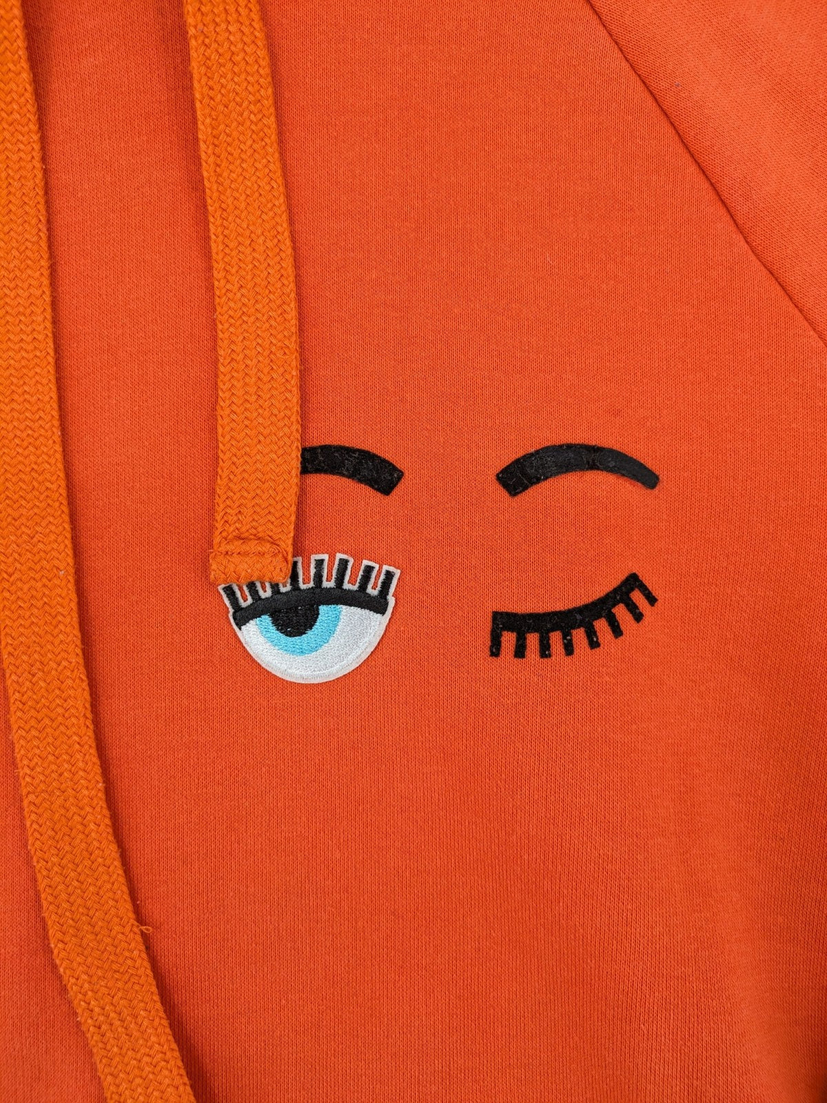 Ginatricot orange hoodie with embroidered winking eye detail, soft material, classic fit.