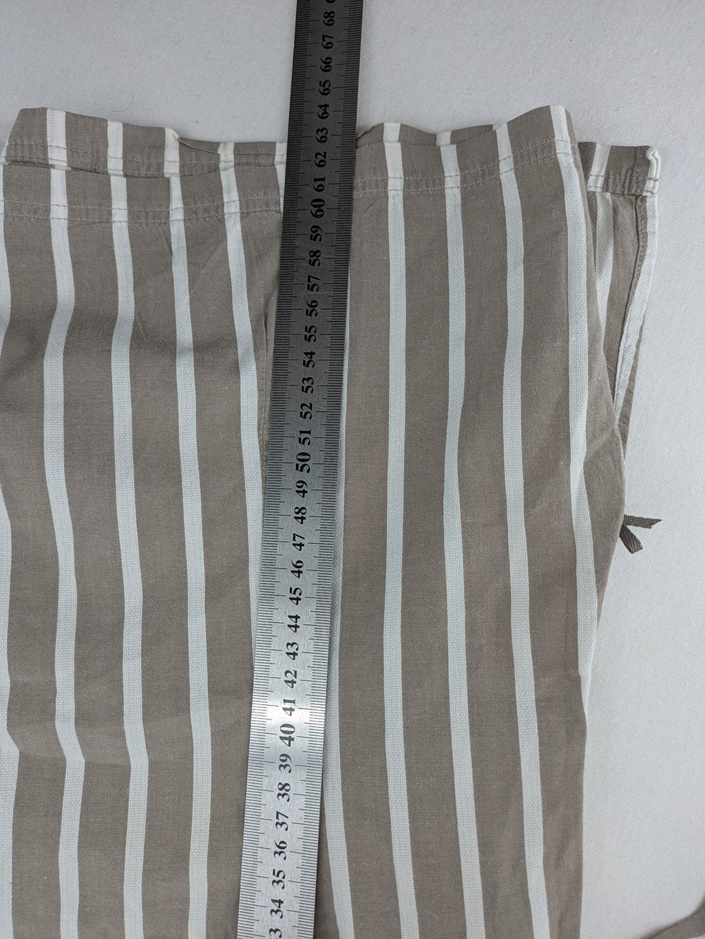 Body Sunday beige and white striped loungewear top with bow accents and button placket.