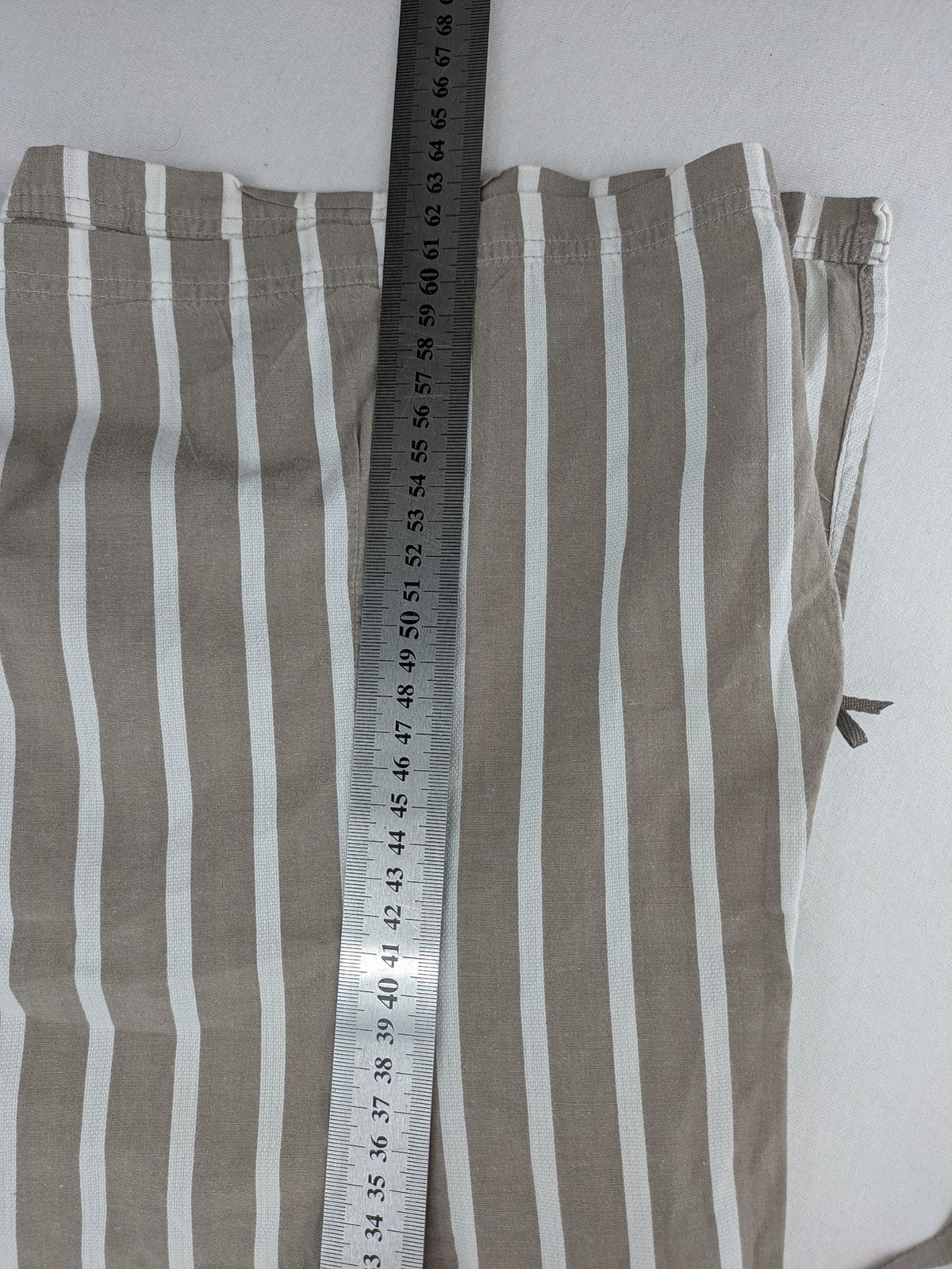 Body Sunday beige and white striped loungewear top with bow accents and button placket.