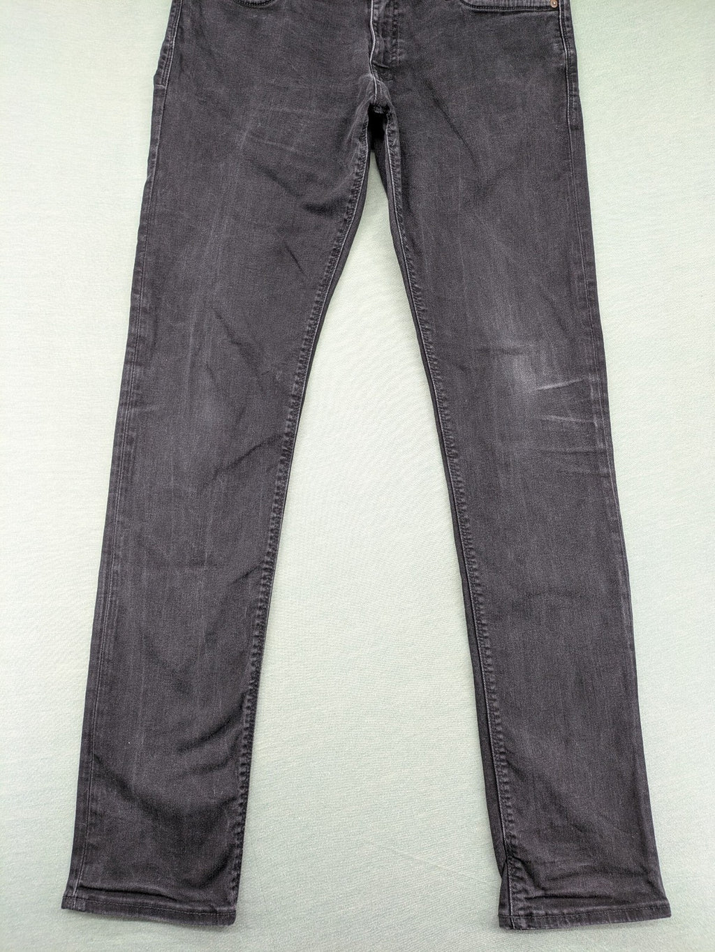 Jack & Jones black slim fit jeans faded wash stretch denim with logo detail.
