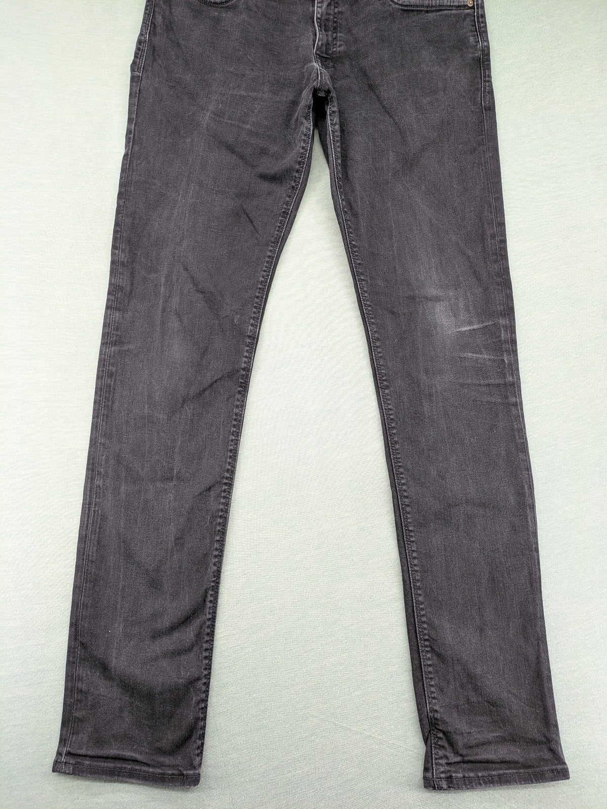Jack & Jones black slim fit jeans faded wash stretch denim with logo detail.