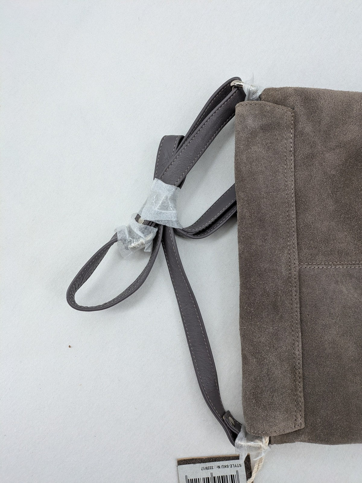 CNTMP grey suede crossbody handbag with flap and silver twist lock closure.