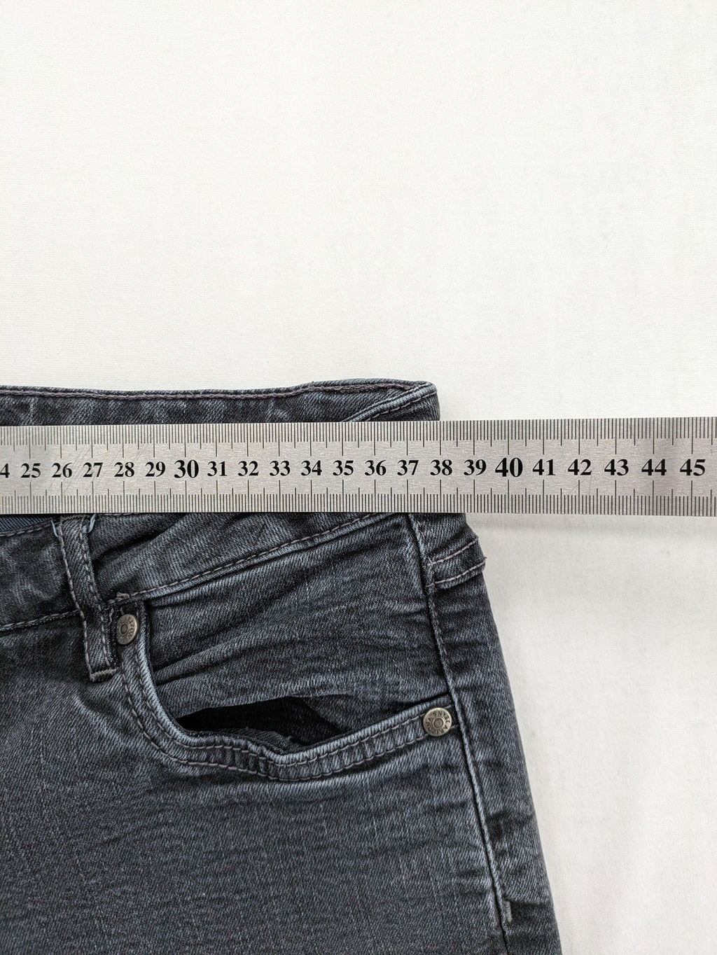 Arizona grey straight jeans with pearl-embellished wing appliqué on back pocket.