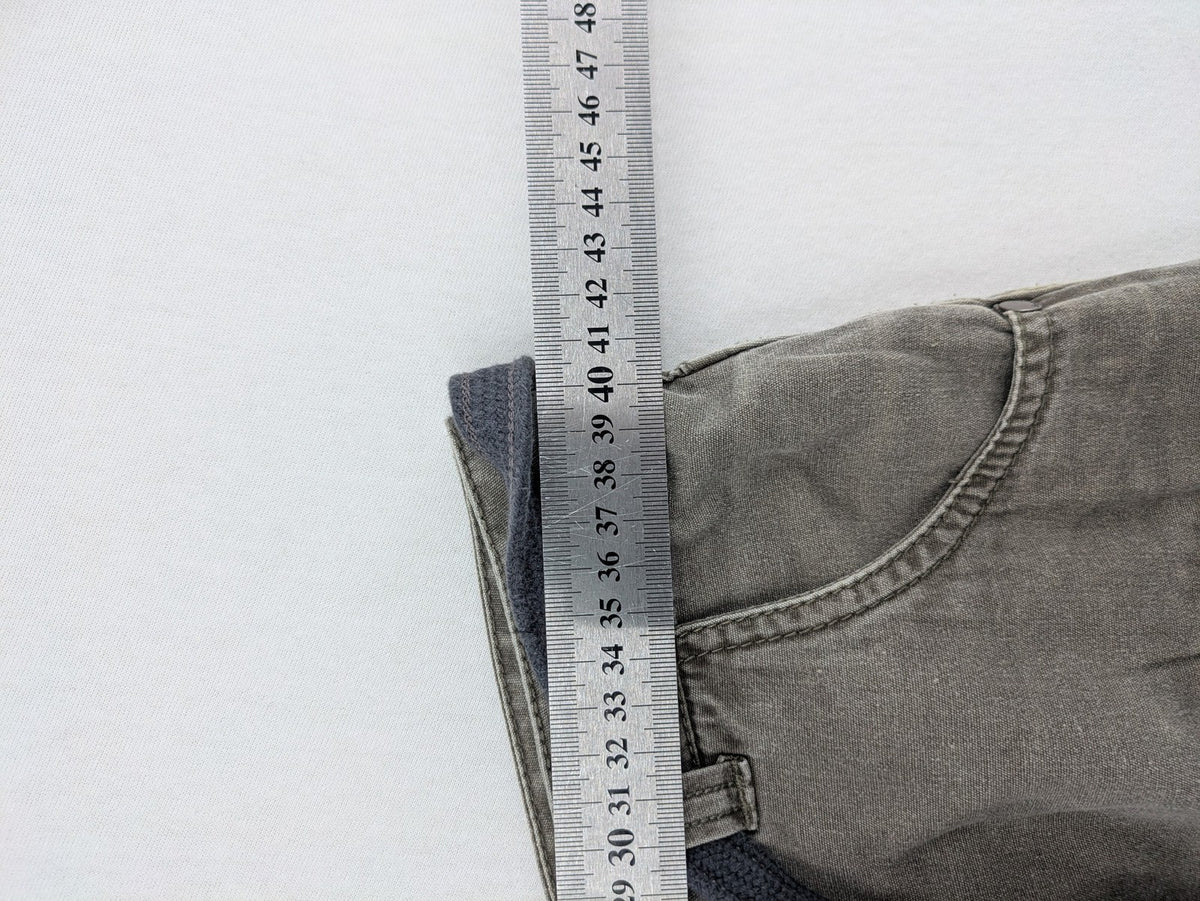 Bench khaki cargo mini skirt with belt, multiple pockets, and durable cotton material.