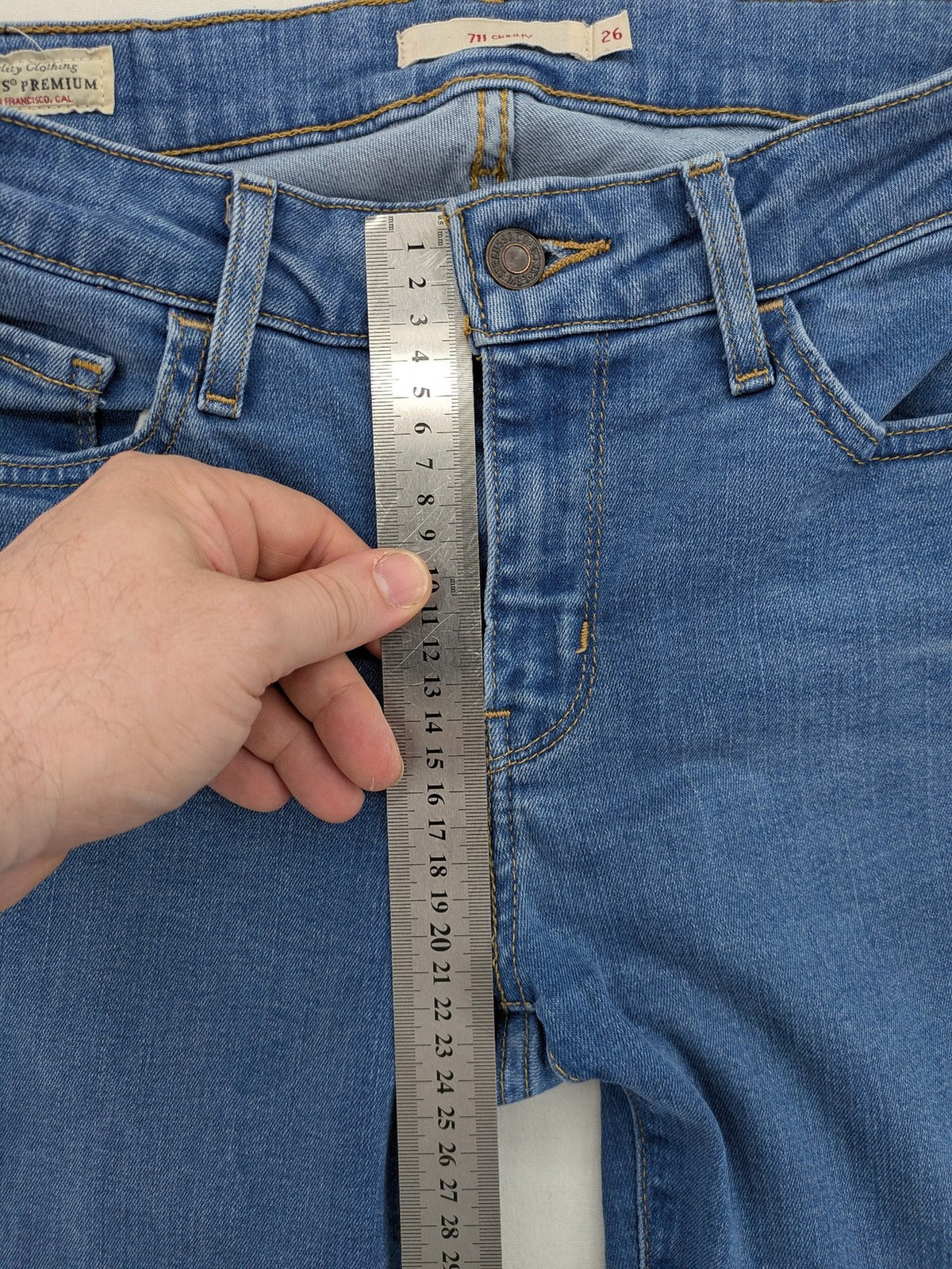 Levi's blue skinny jeans with raw hem, classic five-pocket design, and zip fly.