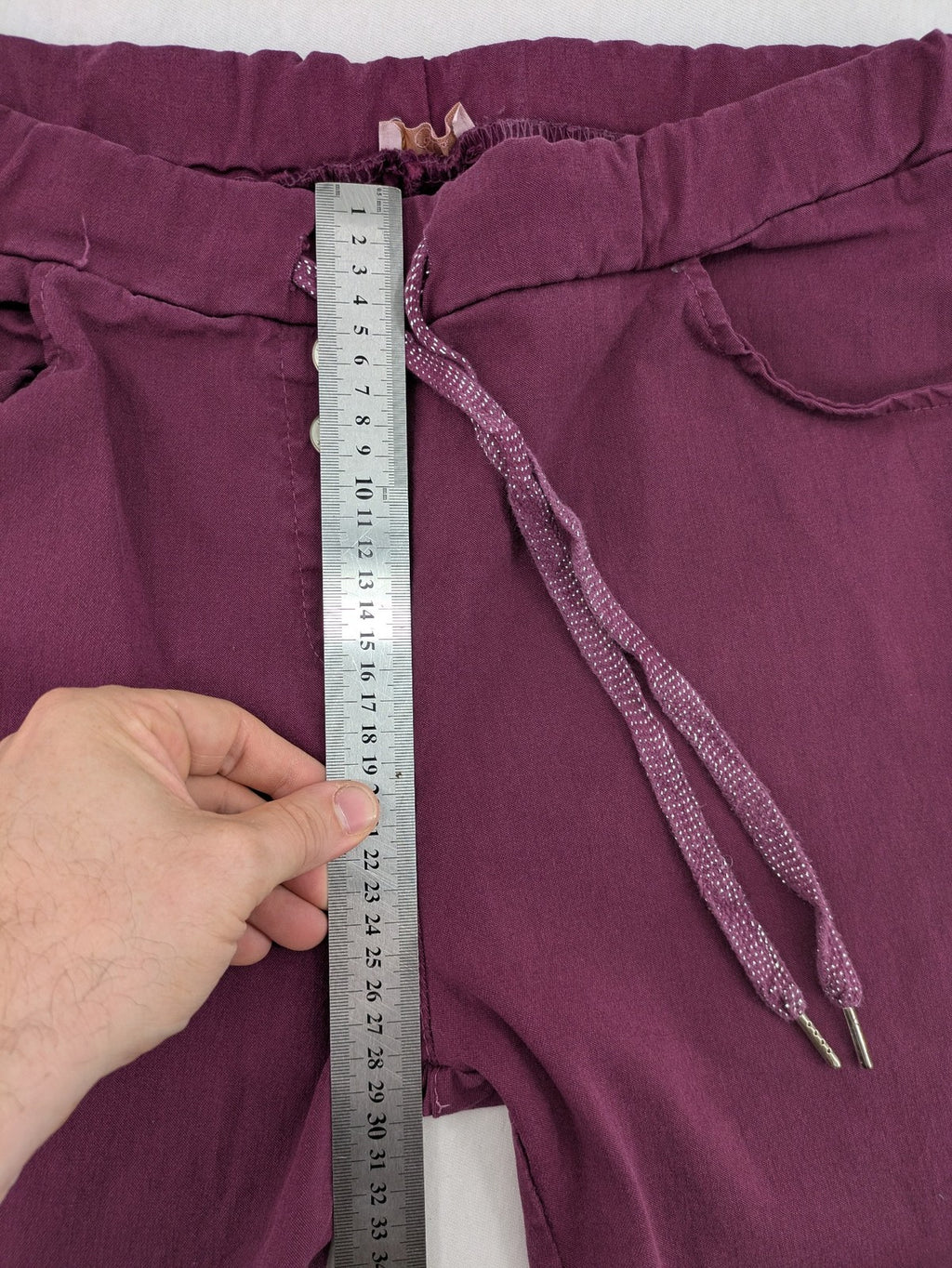 Pink Cherry pants pink stretchy fabric with decorative buttons and elastic waistband.