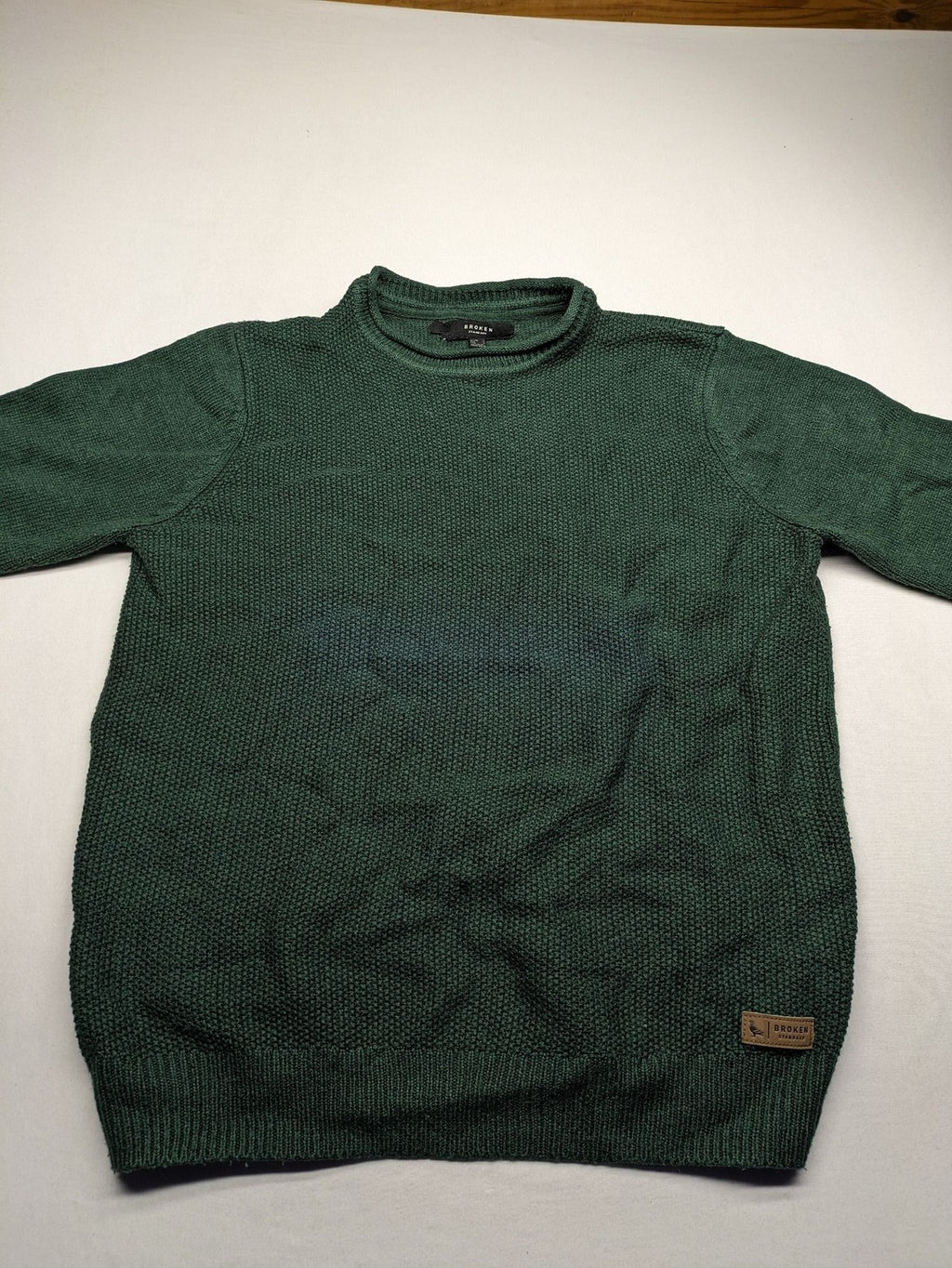 Broken Standard turtle neck jumper green waffle knit texture with classic round neckline.