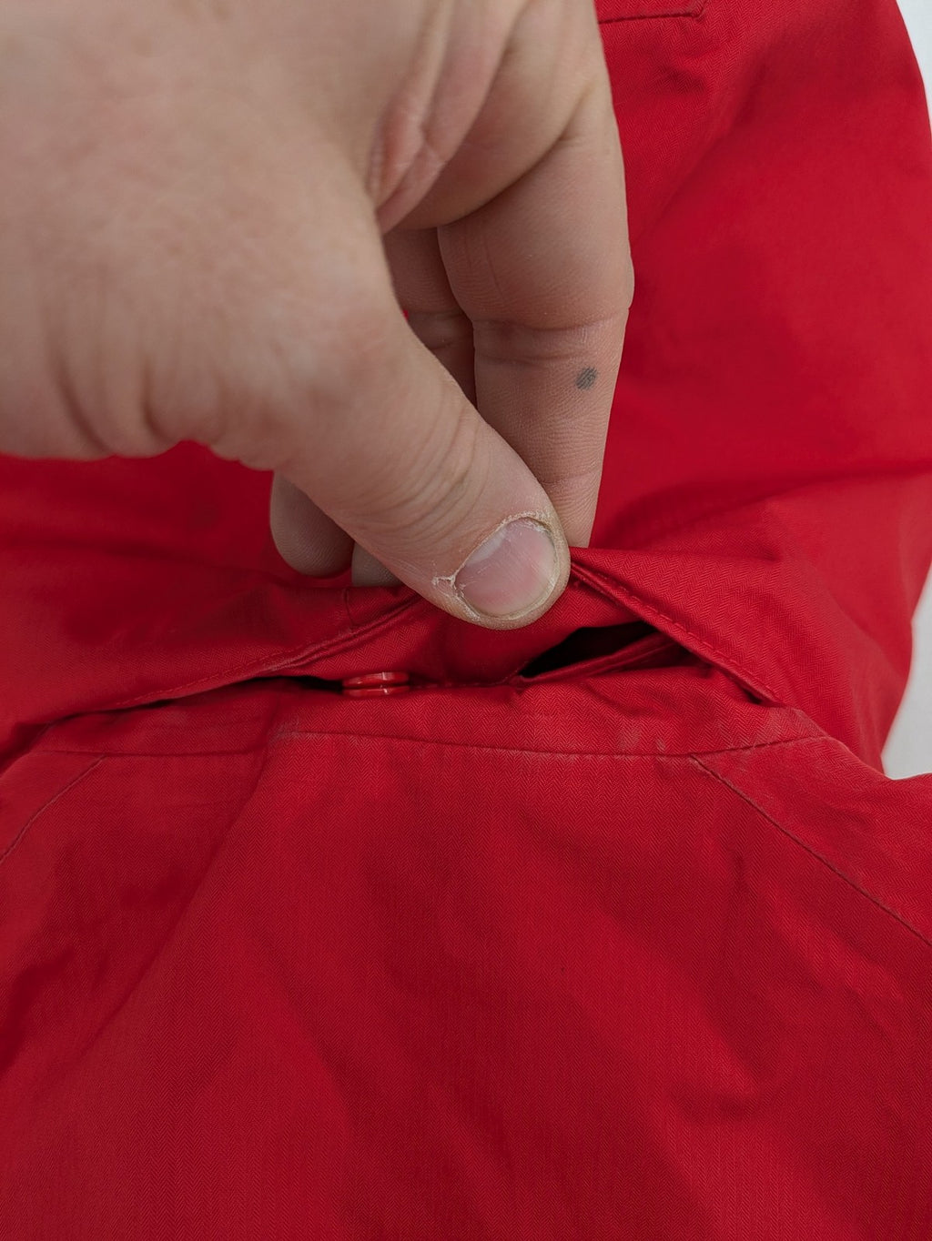 Patagonia red winter coat with hood, zip closure, snow skirt, and ski pass pocket.