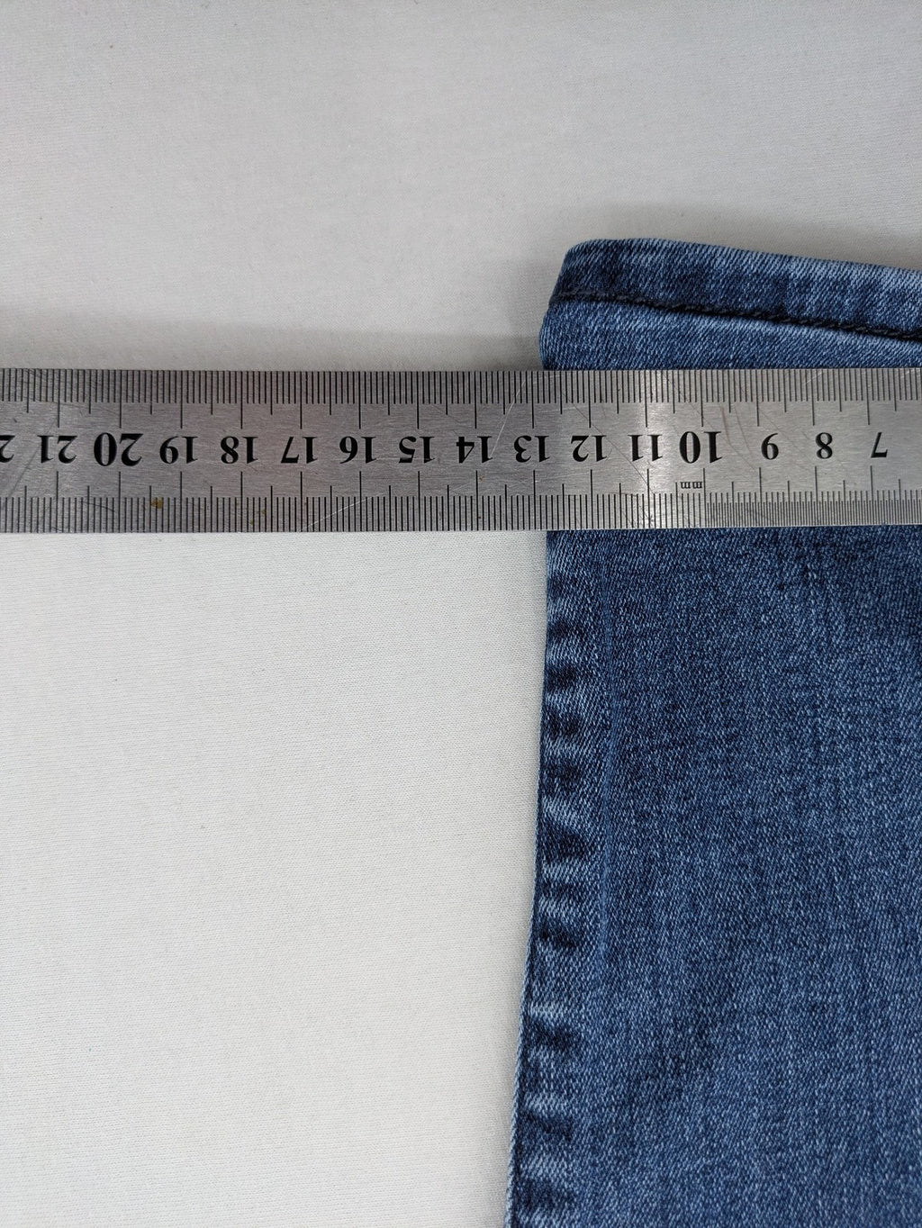 Mavi blue high rise super skinny jeans with medium wash and stretch denim material.