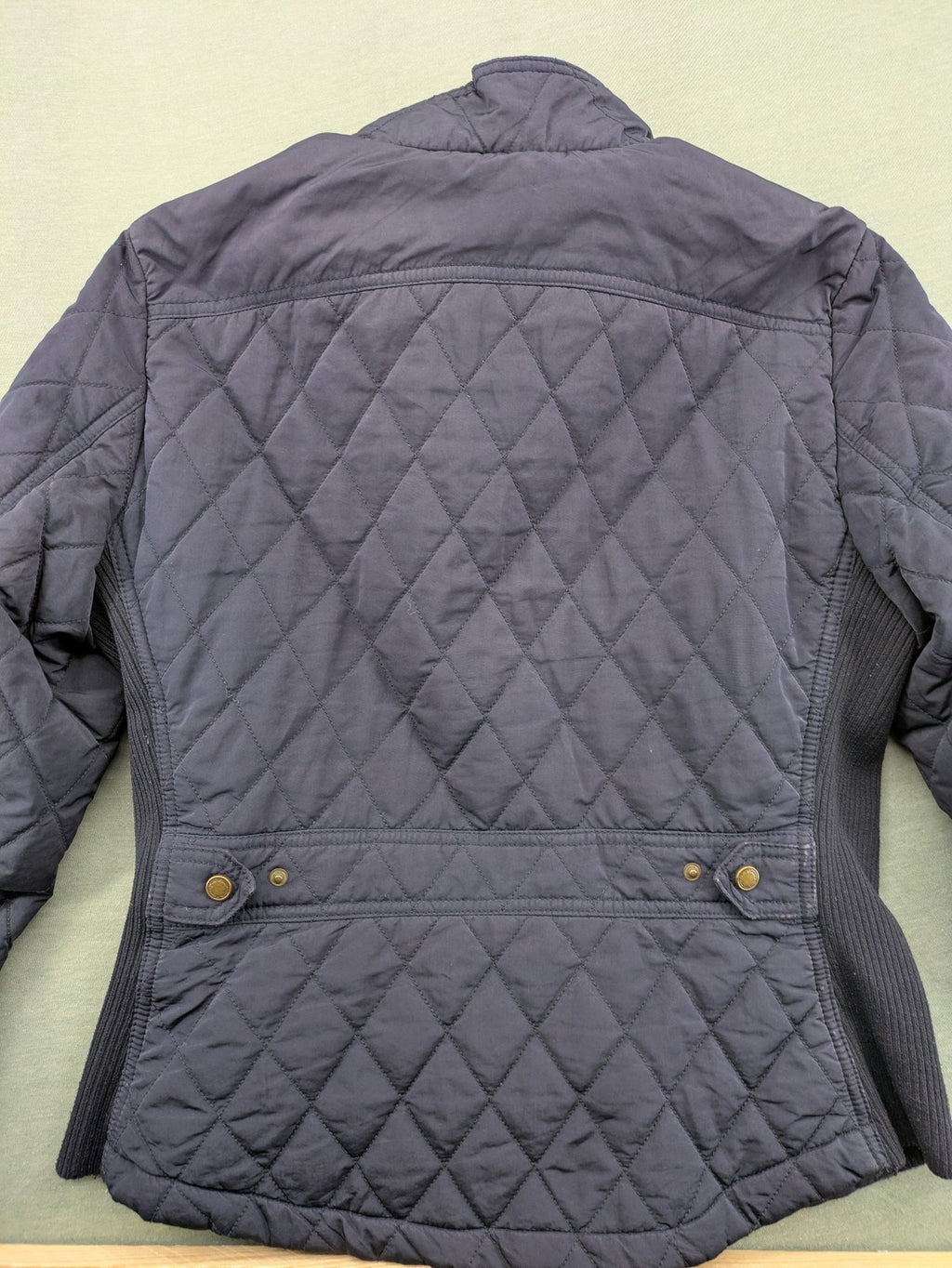Massimo Dutti black quilted jacket with contrasting brown trim and ribbed side inserts.