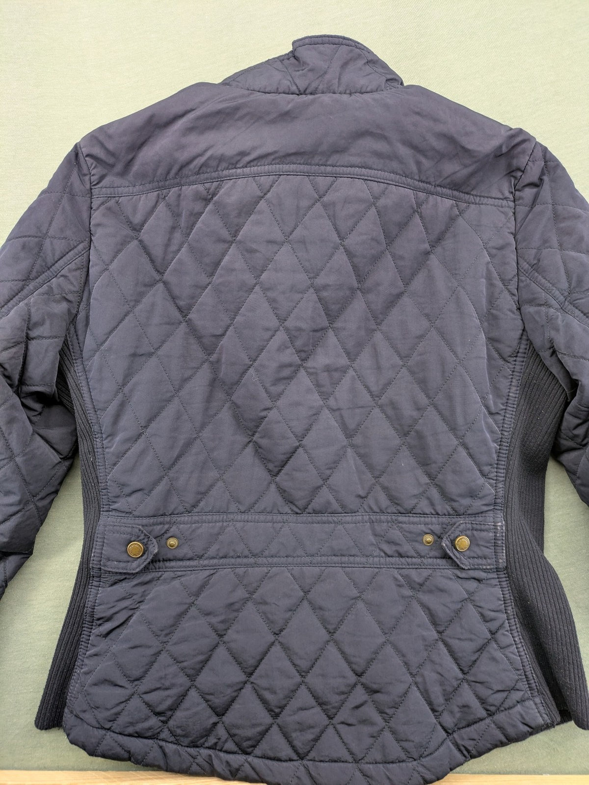 Massimo Dutti black quilted jacket with contrasting brown trim and ribbed side inserts.