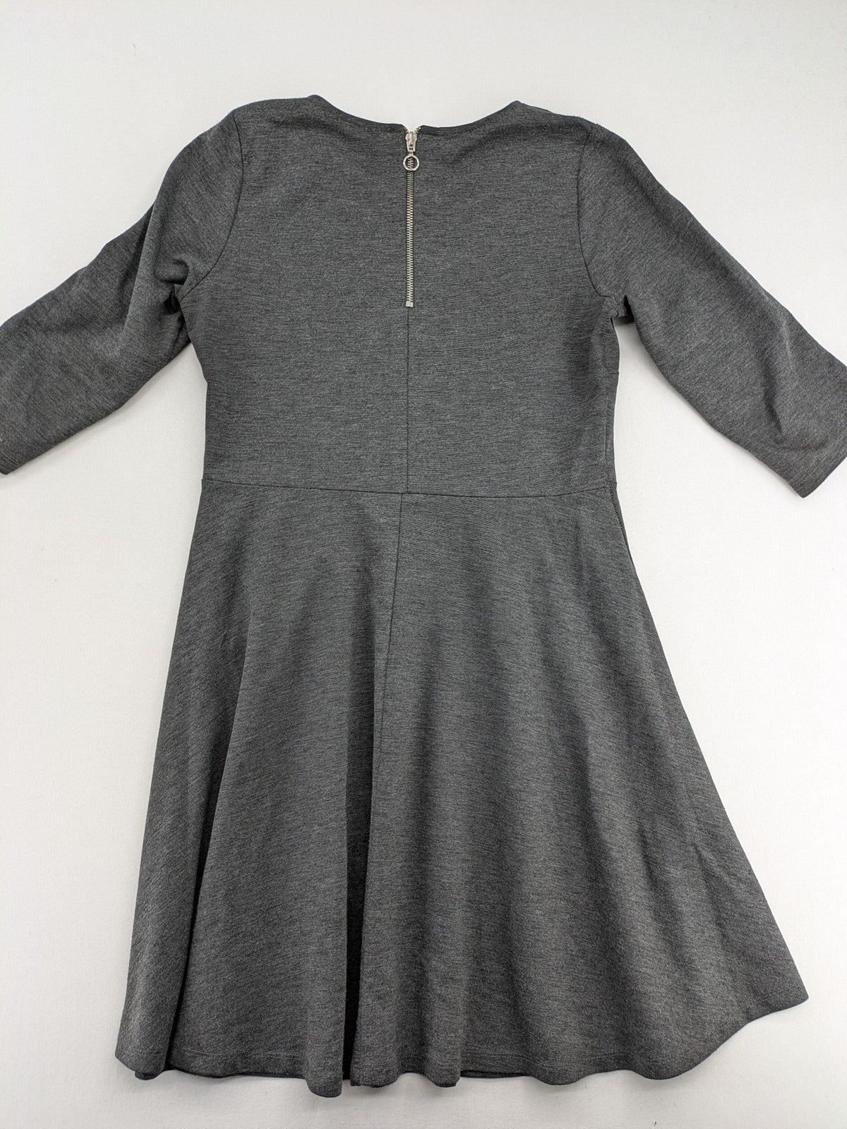 Ginatricot grey A-line skater dress with 3/4 sleeves and visible back zipper.