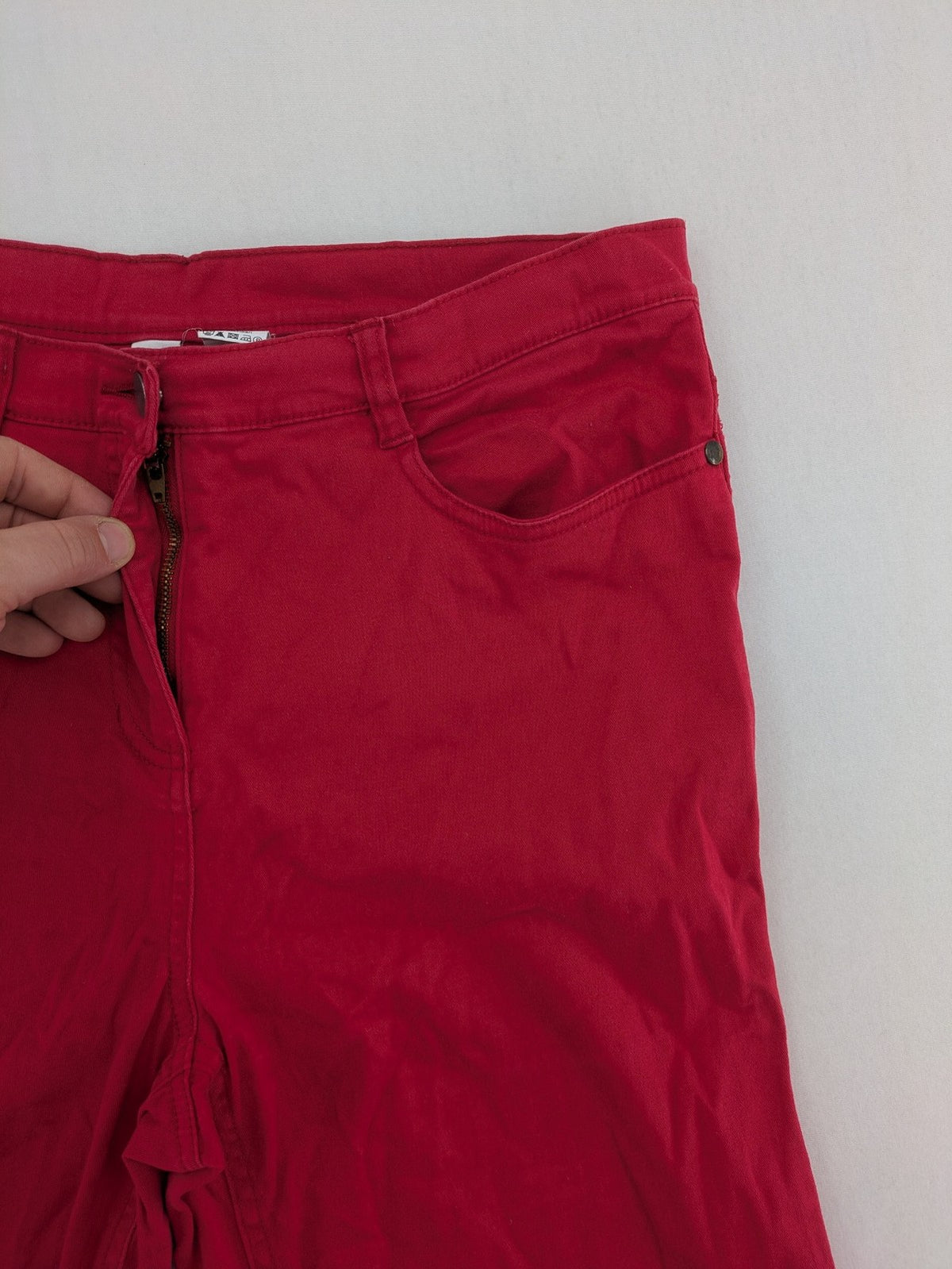 Jet Line red bootcut jeans with embroidered back pockets and pearl embellishments.