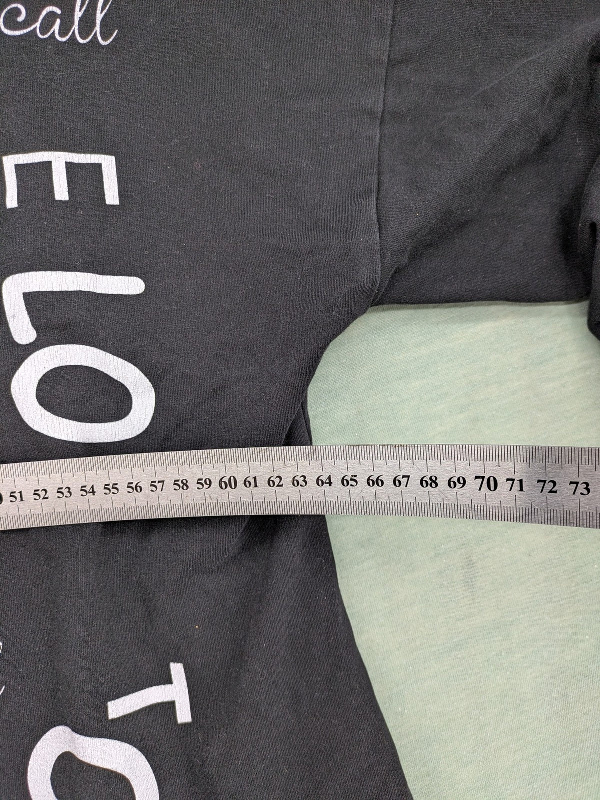 MEGI Collection black hoodie dress with graphic print and asymmetrical high-low hem.