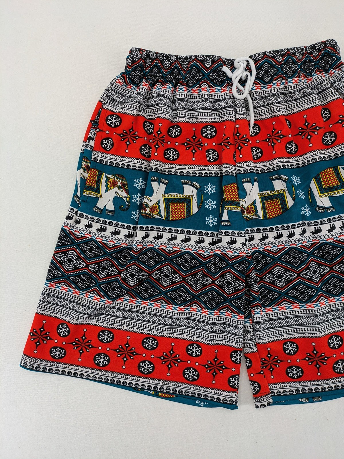 Elefanten multi shorts featuring vibrant elephant and geometric patterns with elastic waistband.