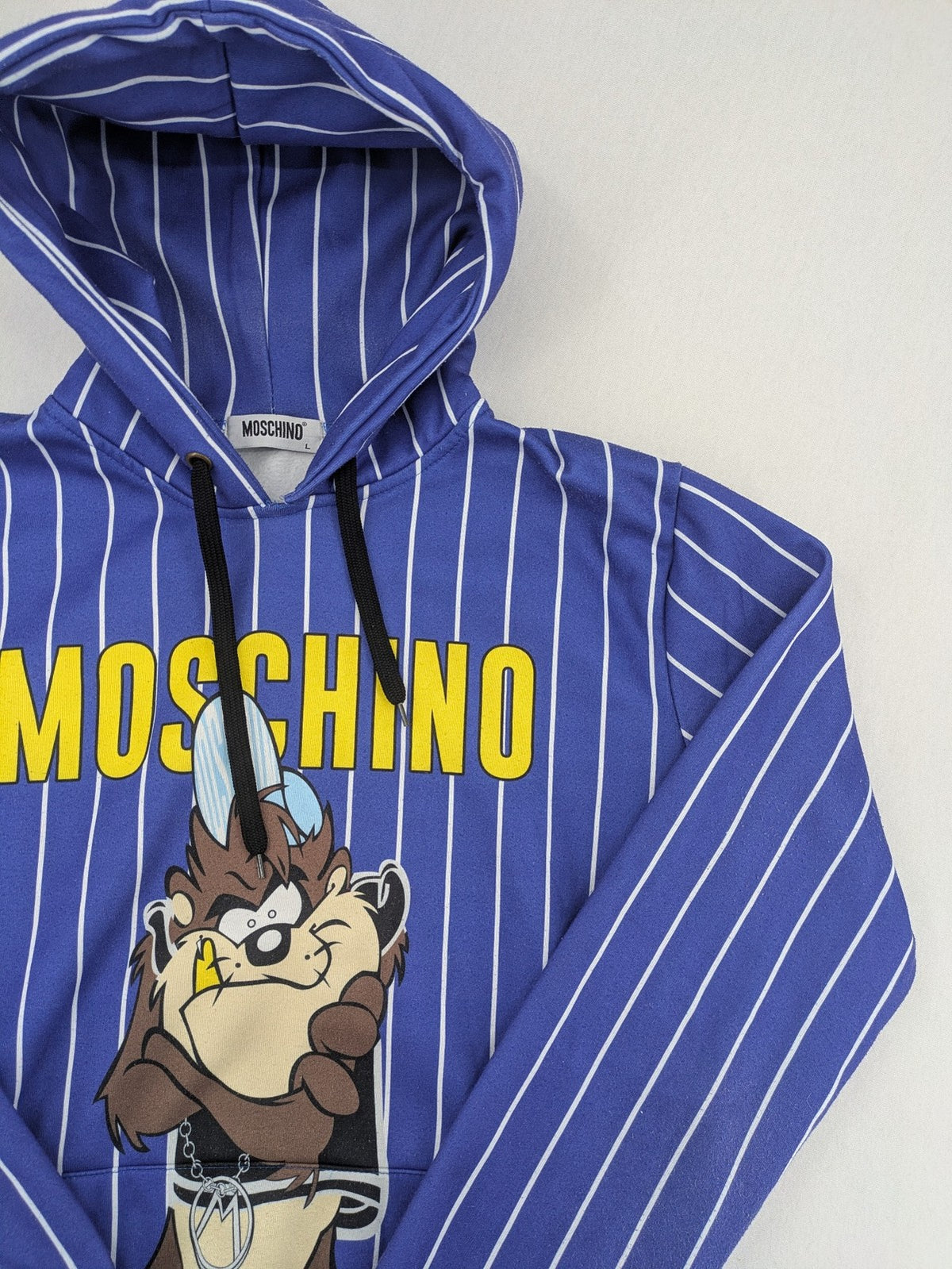 Moschino multi turtle neck jumper blue and white striped with Tasmanian Devil graphic.