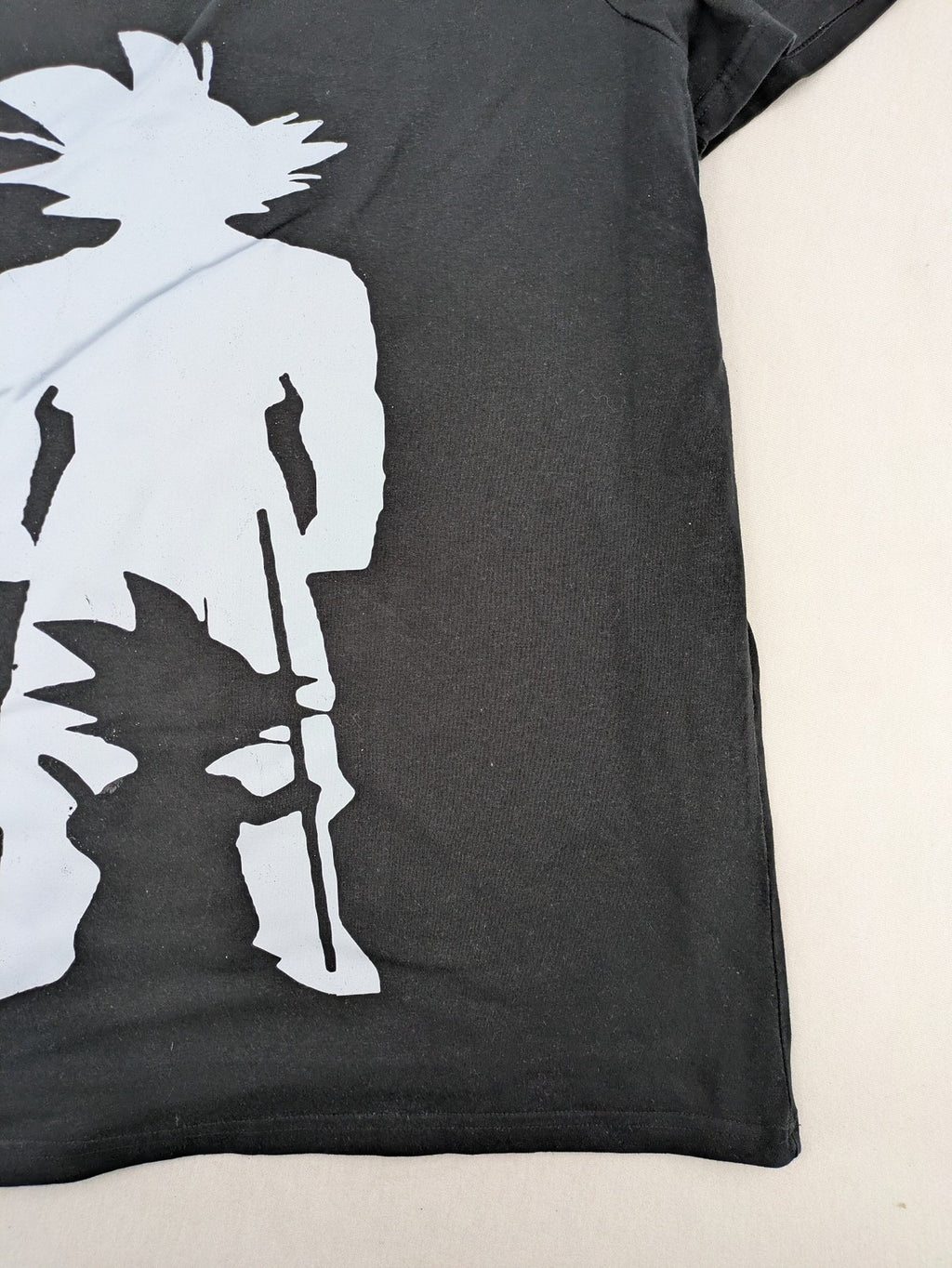 Dragon Ball Z black t-shirt featuring blue Son Goku silhouette graphic design.