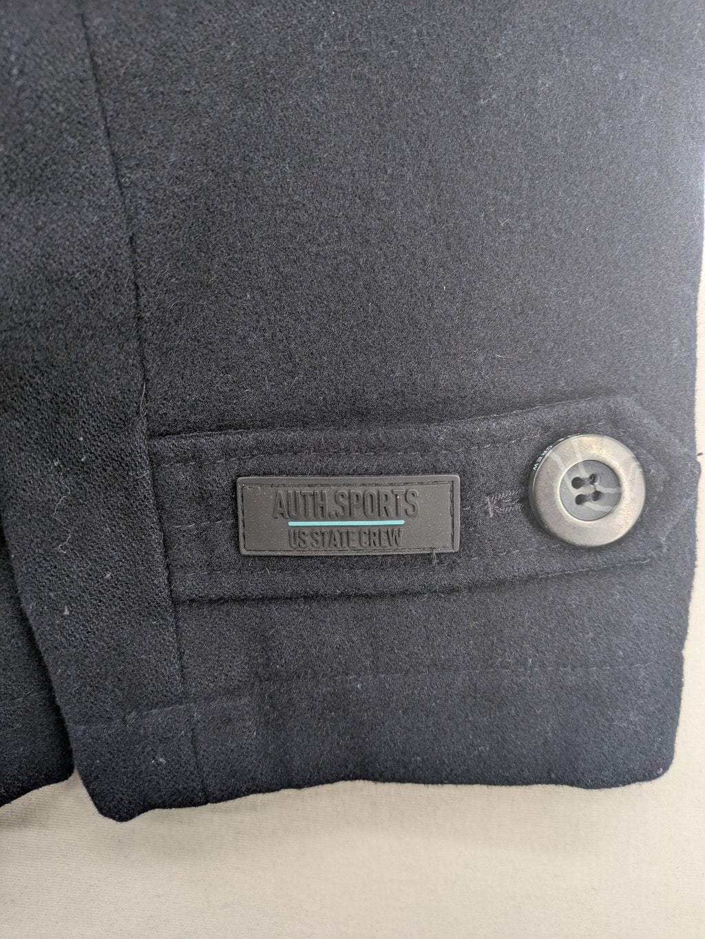Angelo Litrico black duffle coat with toggle closure and cream Sherpa-lined hood.