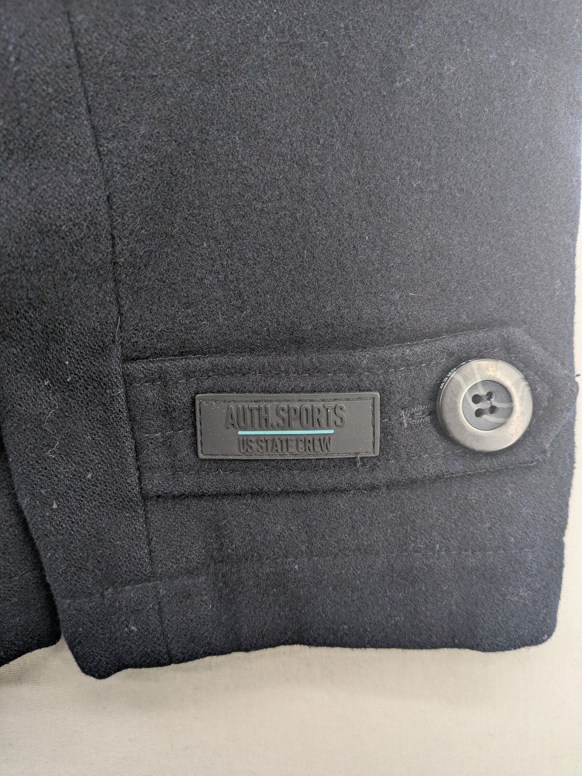 Angelo Litrico black duffle coat with toggle closure and cream Sherpa-lined hood.