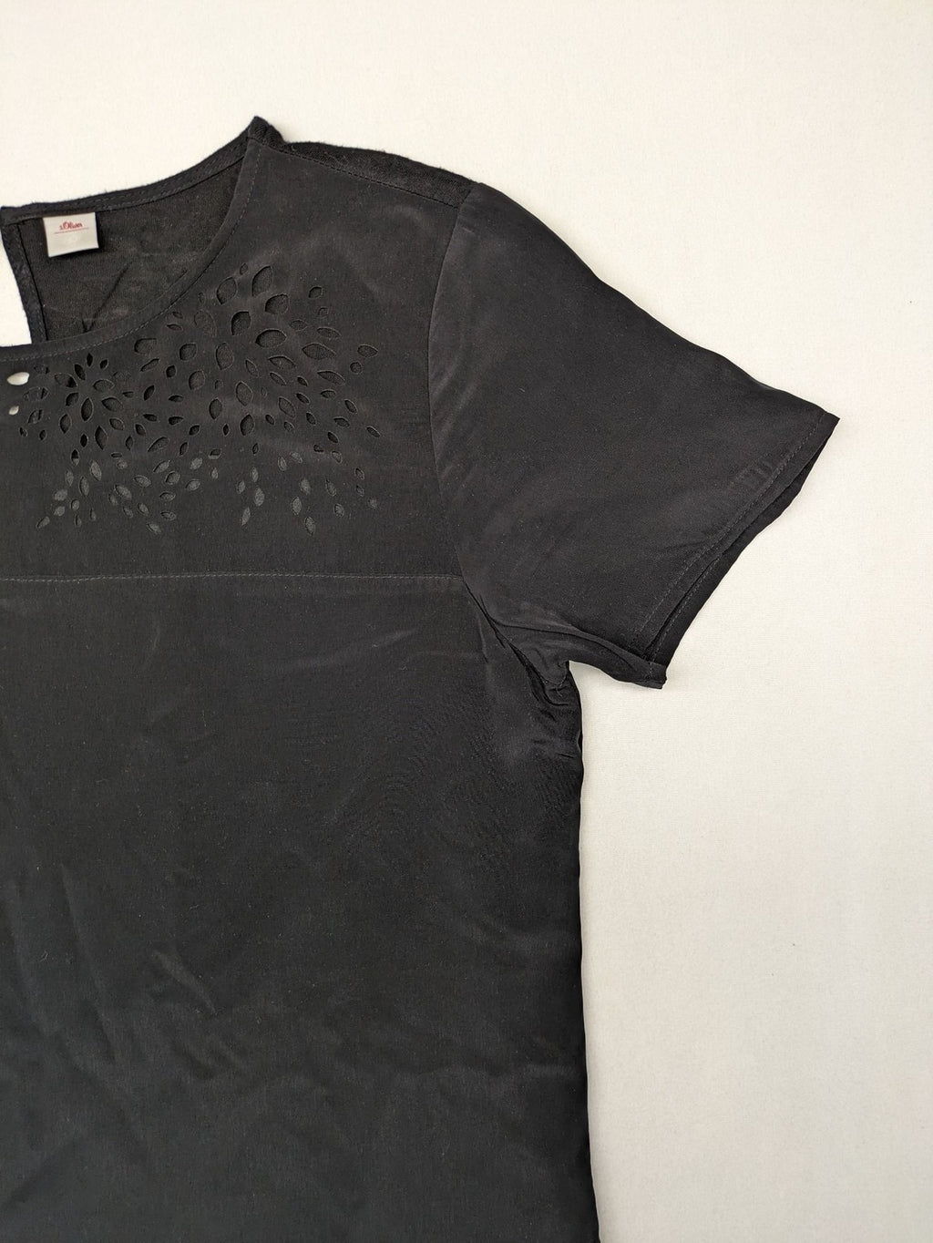 s.Oliver black shift dress with intricate cut-out pattern and keyhole neck detail.