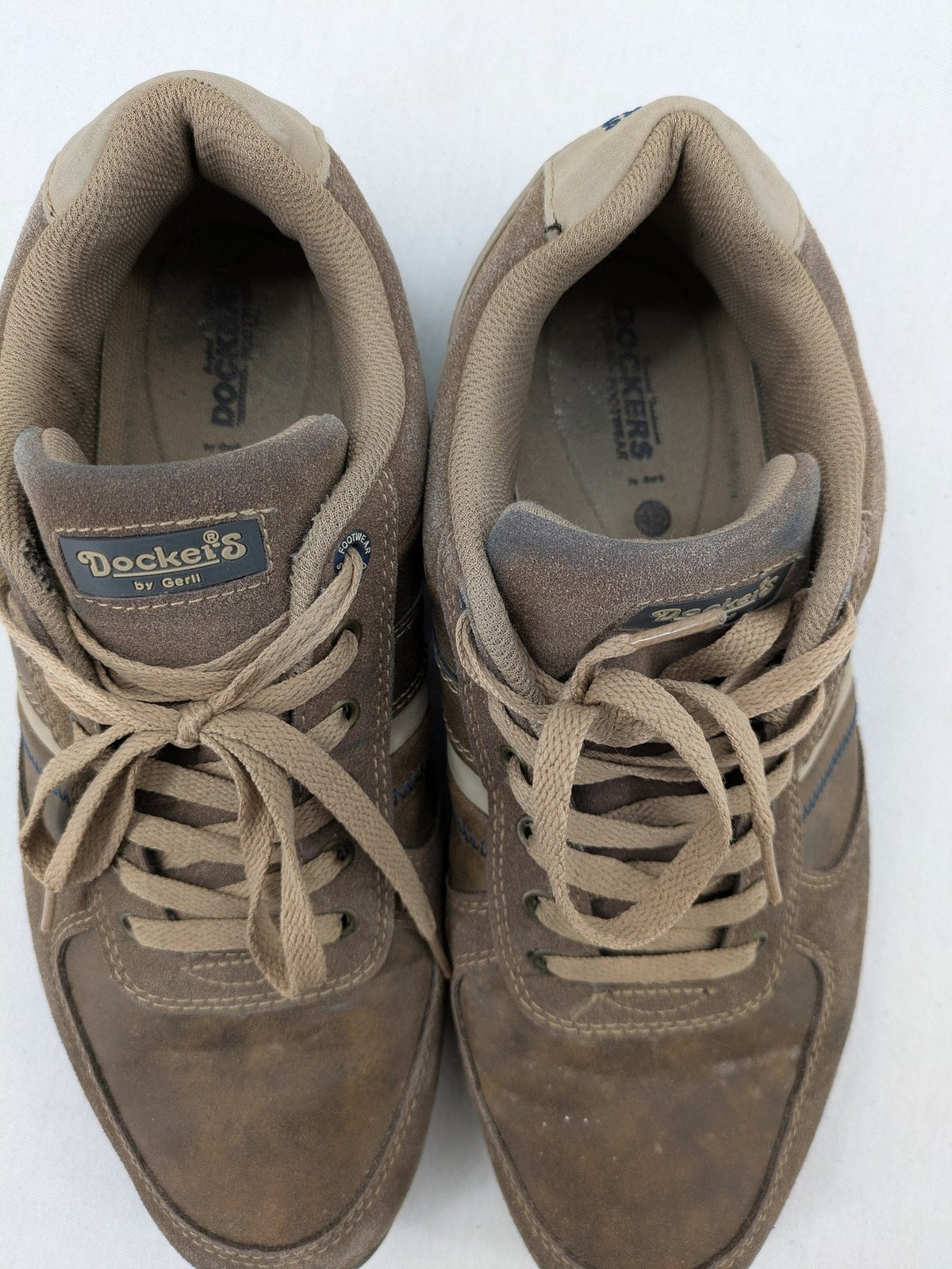 Dockers brown sneakers with subtle light brown and blue accents, lace-up design.