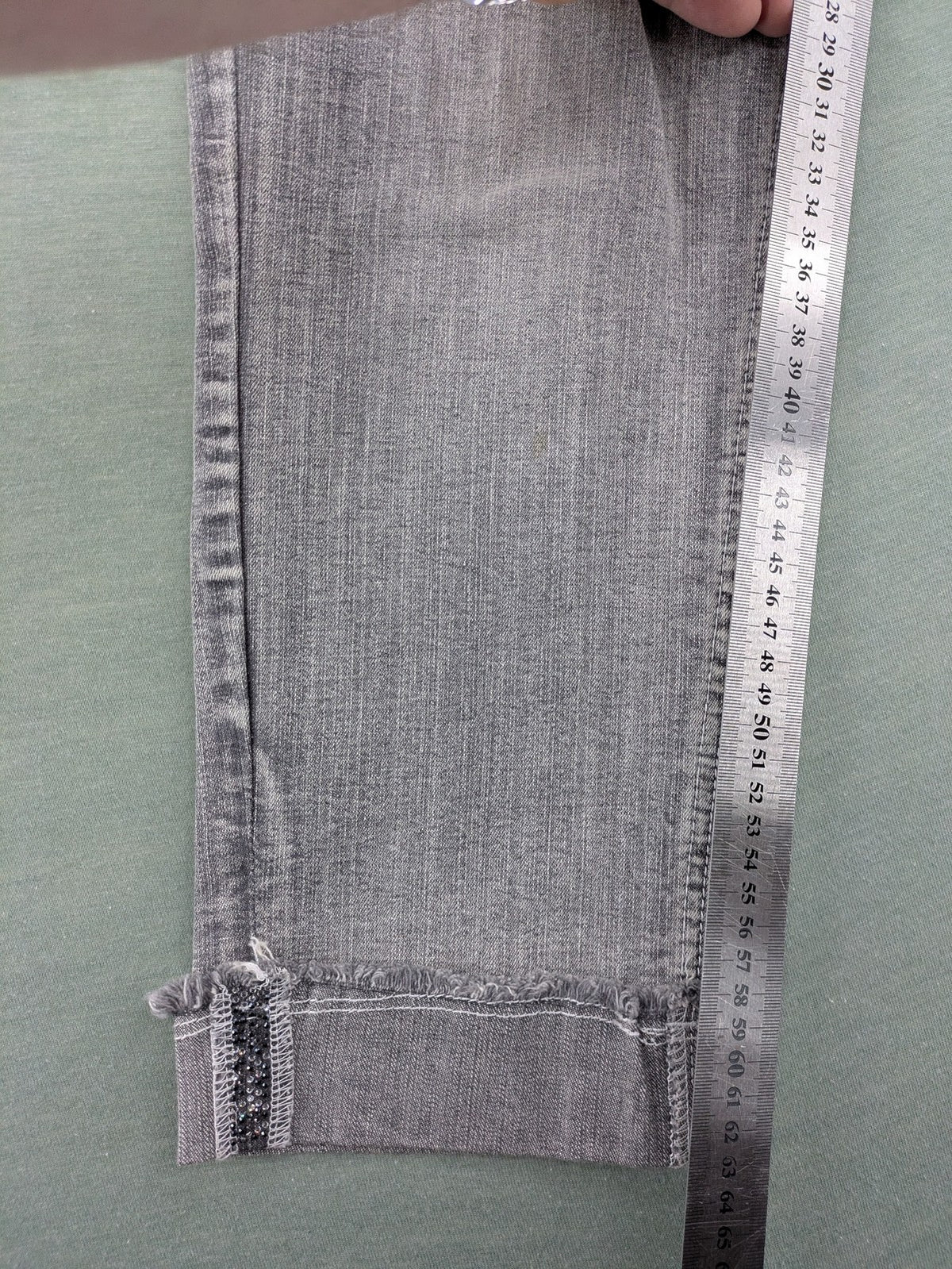 Rick Cardona grey cropped straight jeans with frayed hems and sparkling rhinestone details.