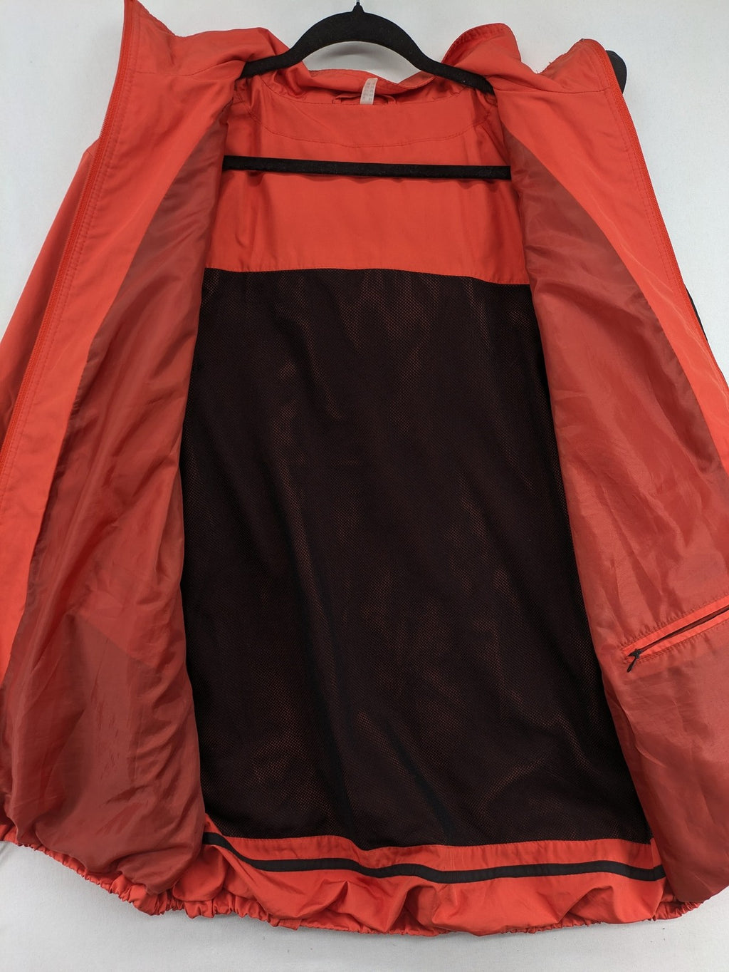 Sport Windbreaker orange jacket with adjustable hood, full zip, and button storm flap.