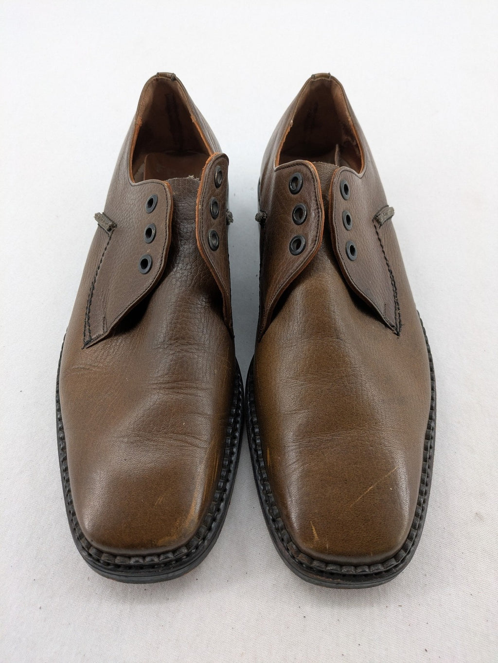 Fonda brown deck shoes genuine leather square toe design with decorative stitching.