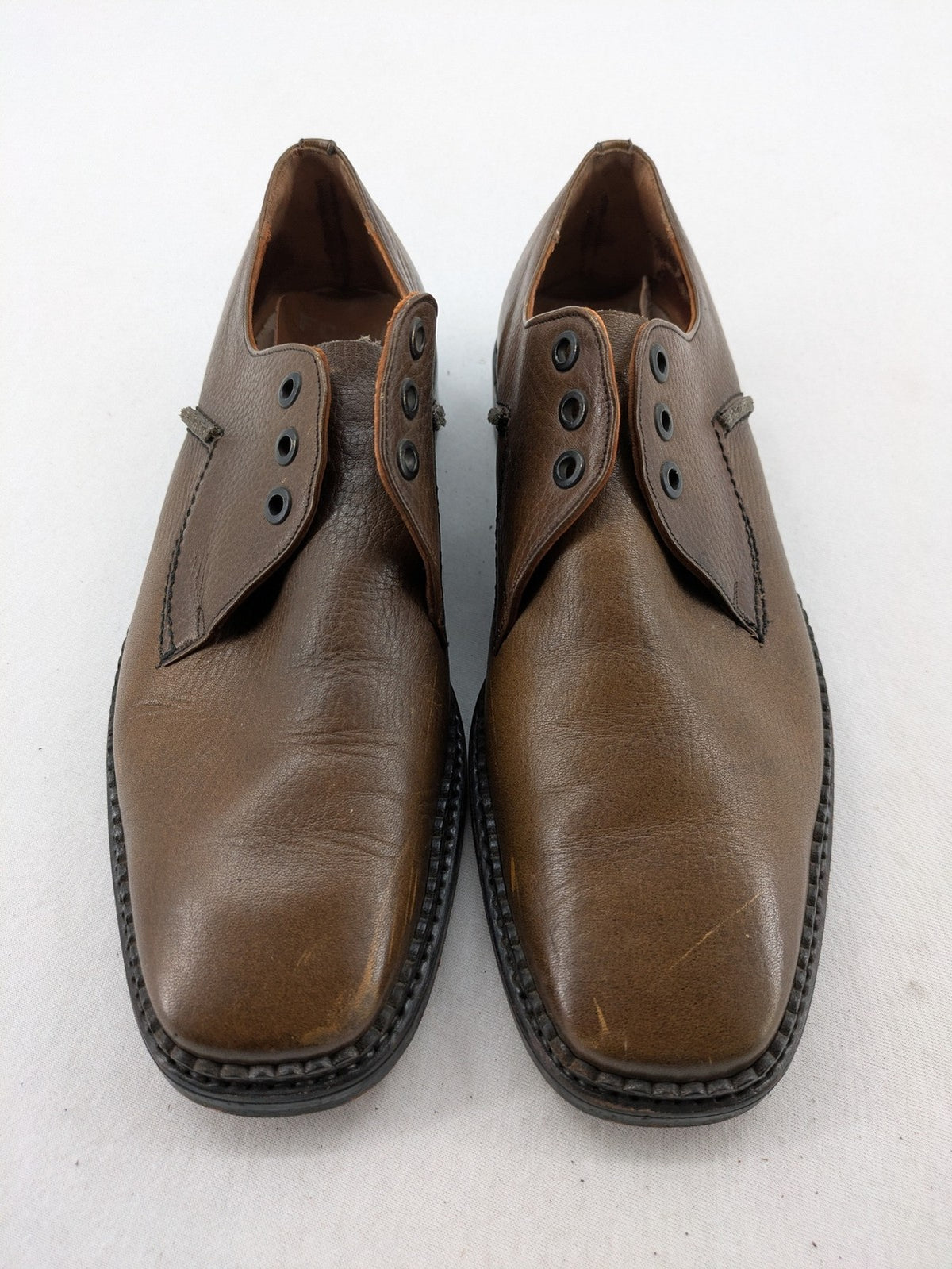 Fonda brown deck shoes genuine leather square toe design with decorative stitching.