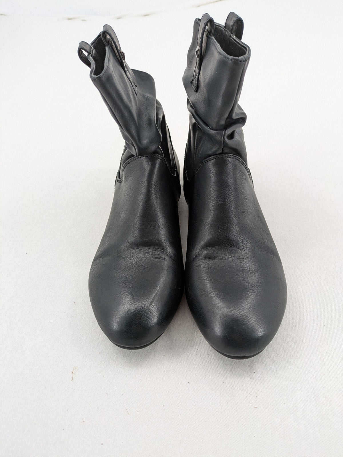 DAF black booties with decorative strap and studded details, made of faux leather.