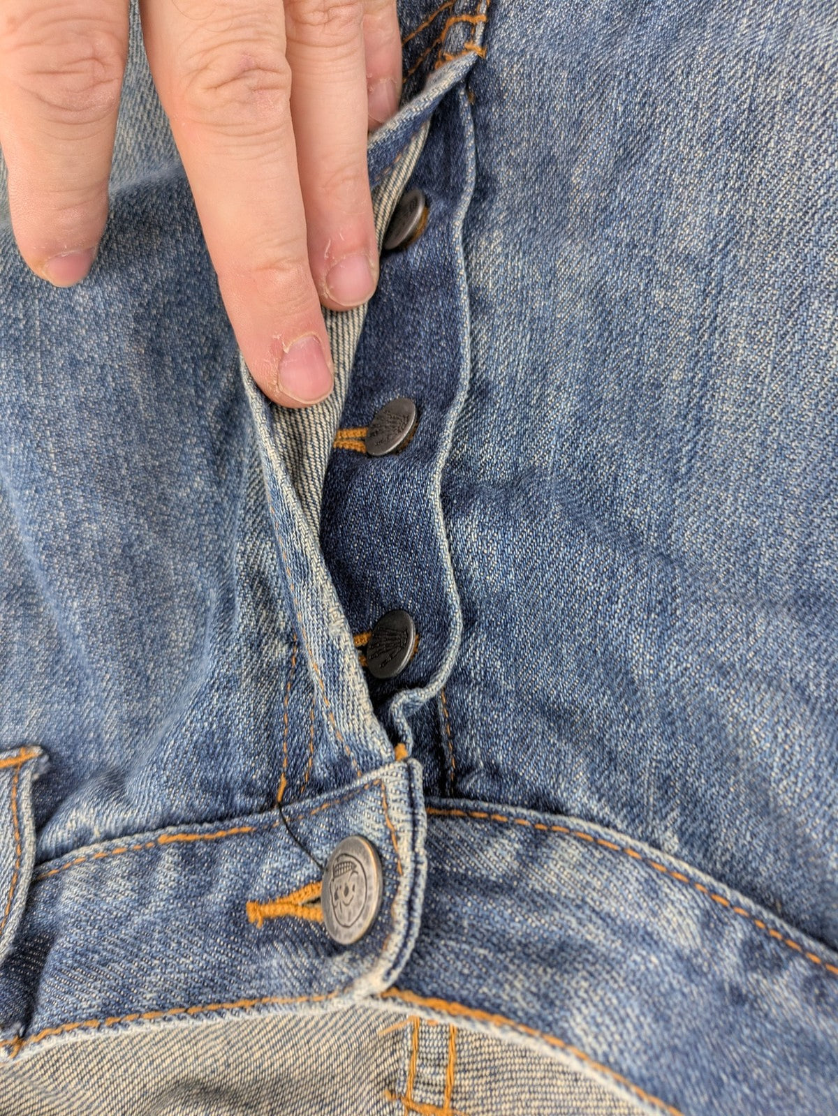 Cheap Monday blue straight jeans with button fly and classic medium wash finish.