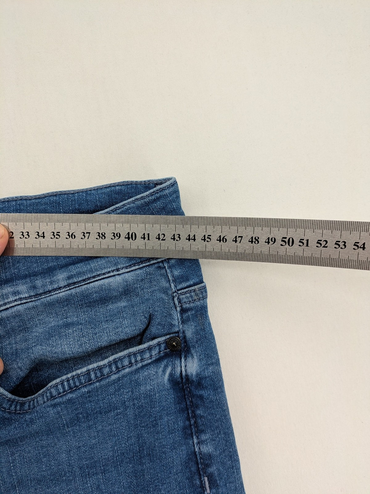 7 For All Mankind blue straight jeans with 5-pocket design and logo on back pocket.