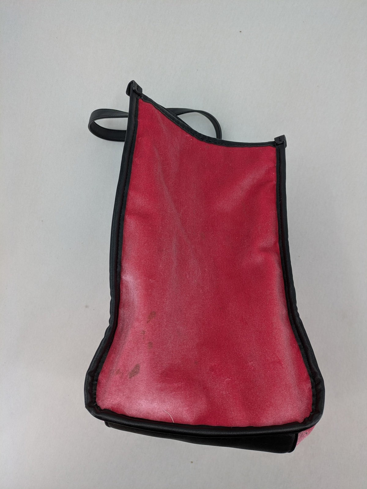 Juicy Couture pink velour handbag with oversized black logo and faux leather straps.