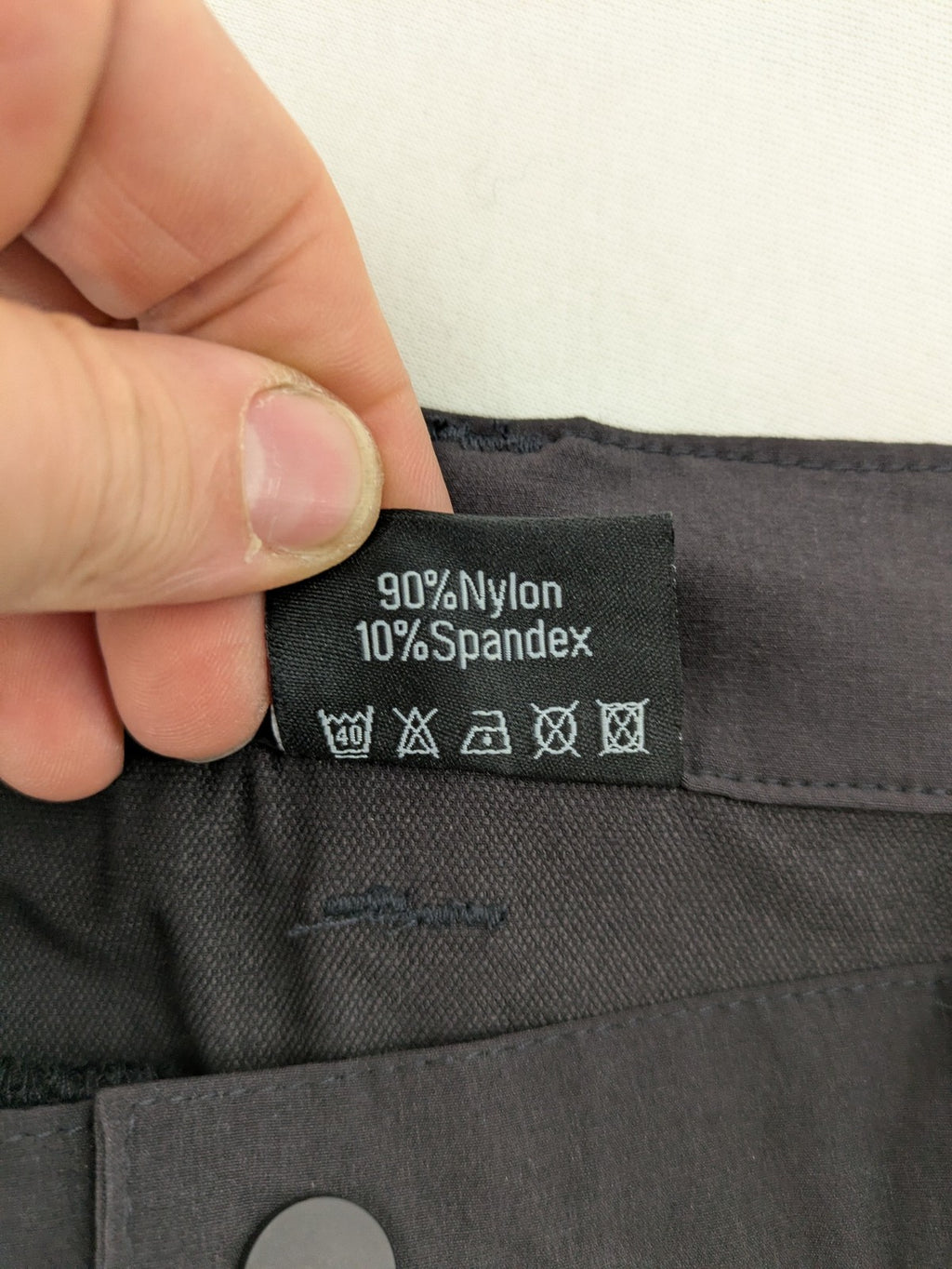 Outdoor black capri pants with elastic waistband and multiple zippered pockets.