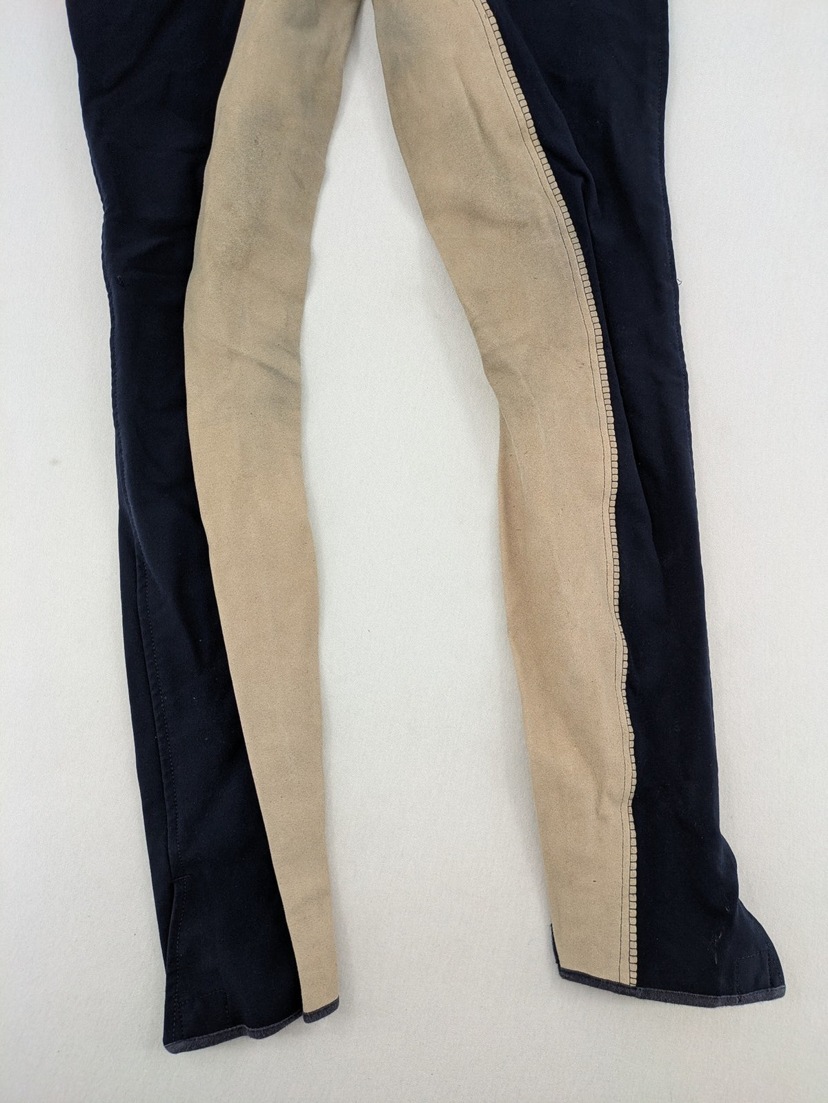 H&KM beige riding pants with dark blue full seat and front zippers.