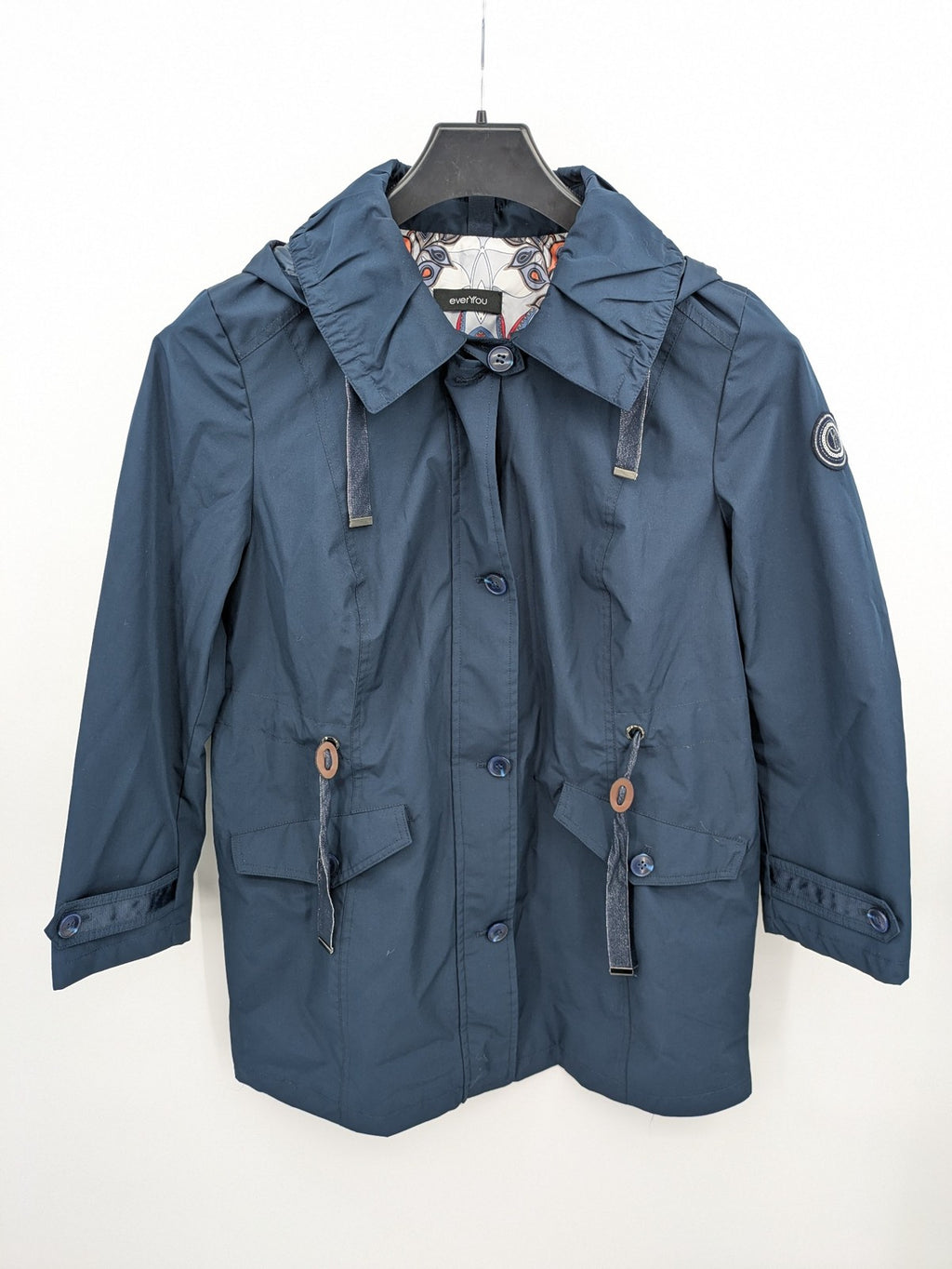 everYou navy parka jacket with hood, adjustable drawstring, patterned lining, button closure.