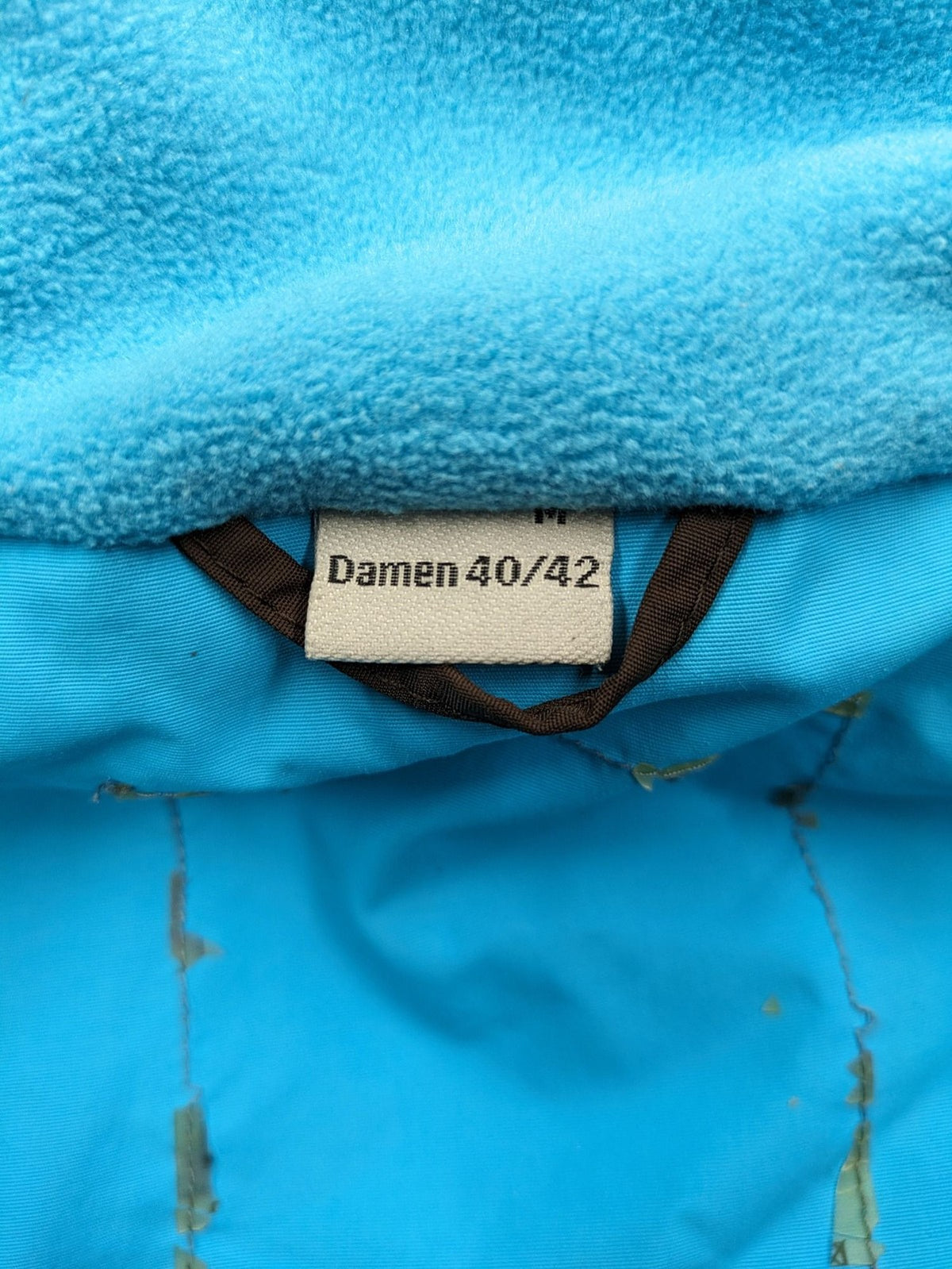 Thinsulate black and blue ski jumpsuit with hood and zippered pockets.