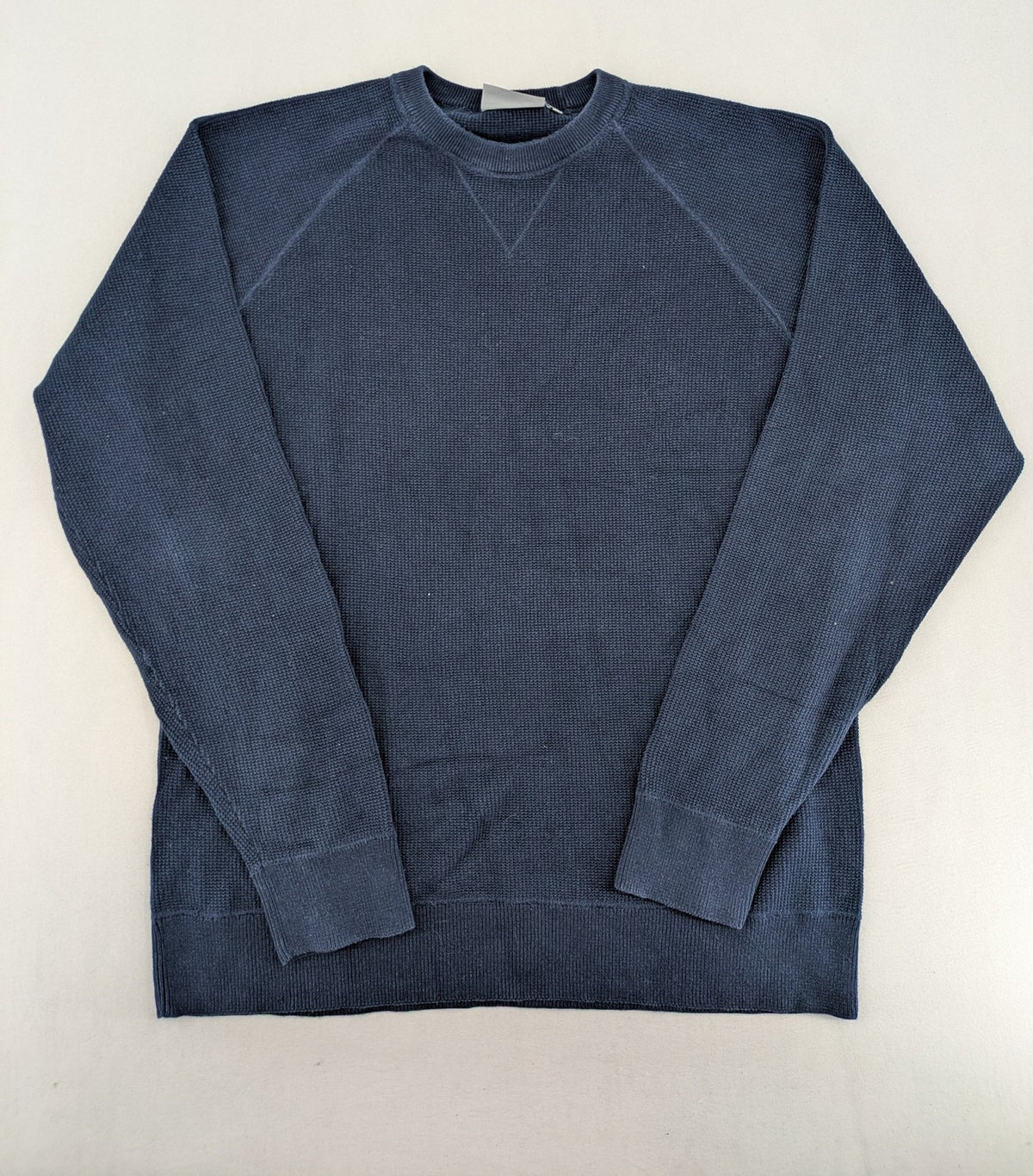 Carhartt navy turtle neck jumper waffle knit texture with subtle logo on sleeve.