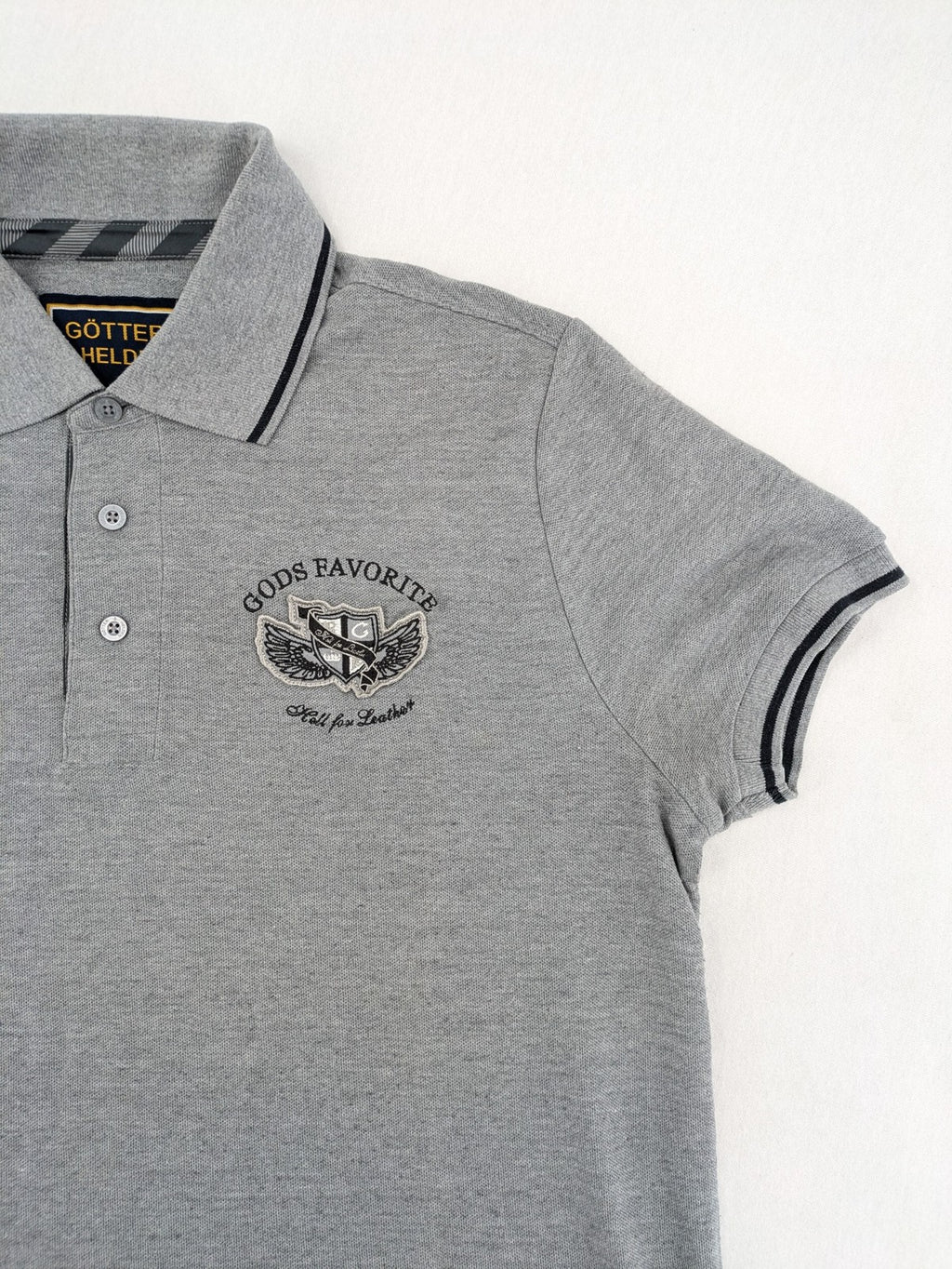Götter & Helden grey polo shirt with "Gods Favorite" embroidery and contrasting collar details.