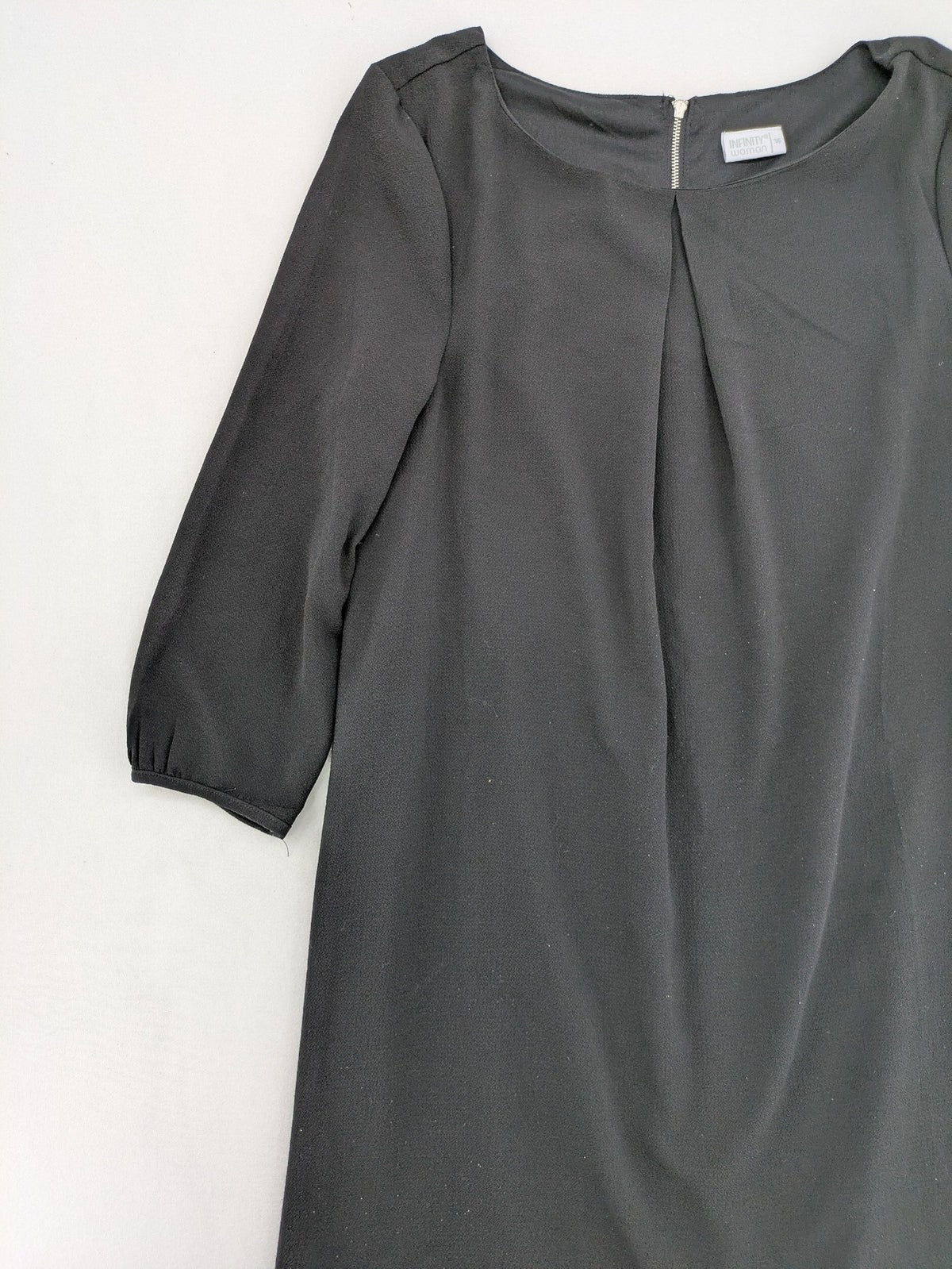 Infinity grey bridal party dress with pleated front and 3/4 sleeves.