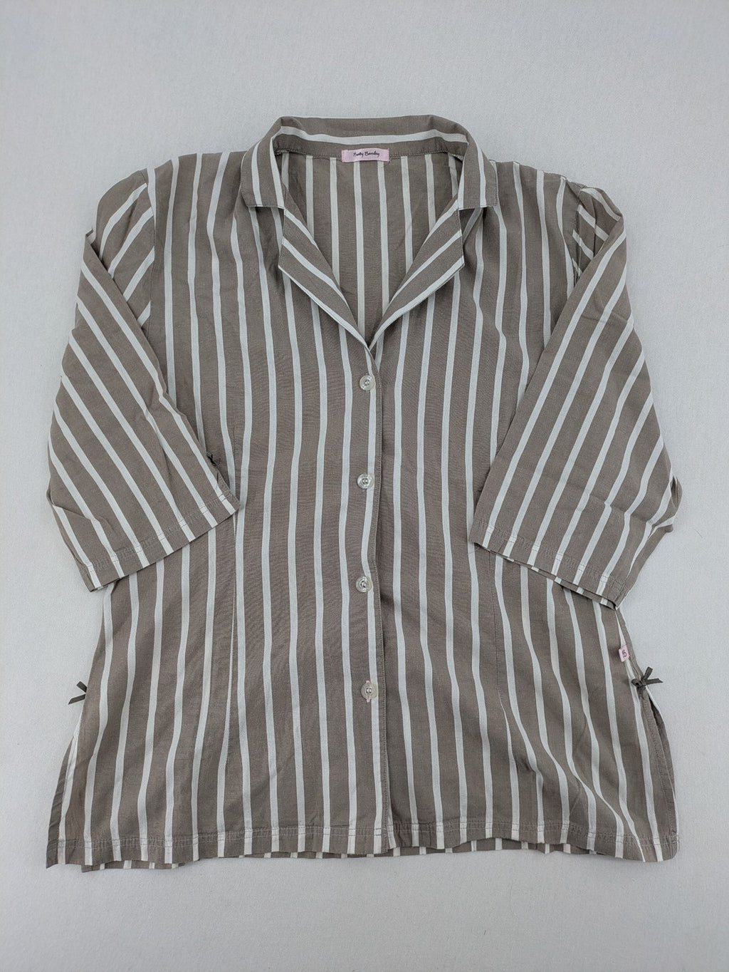 Body Sunday beige and white striped loungewear top with bow accents and button placket.