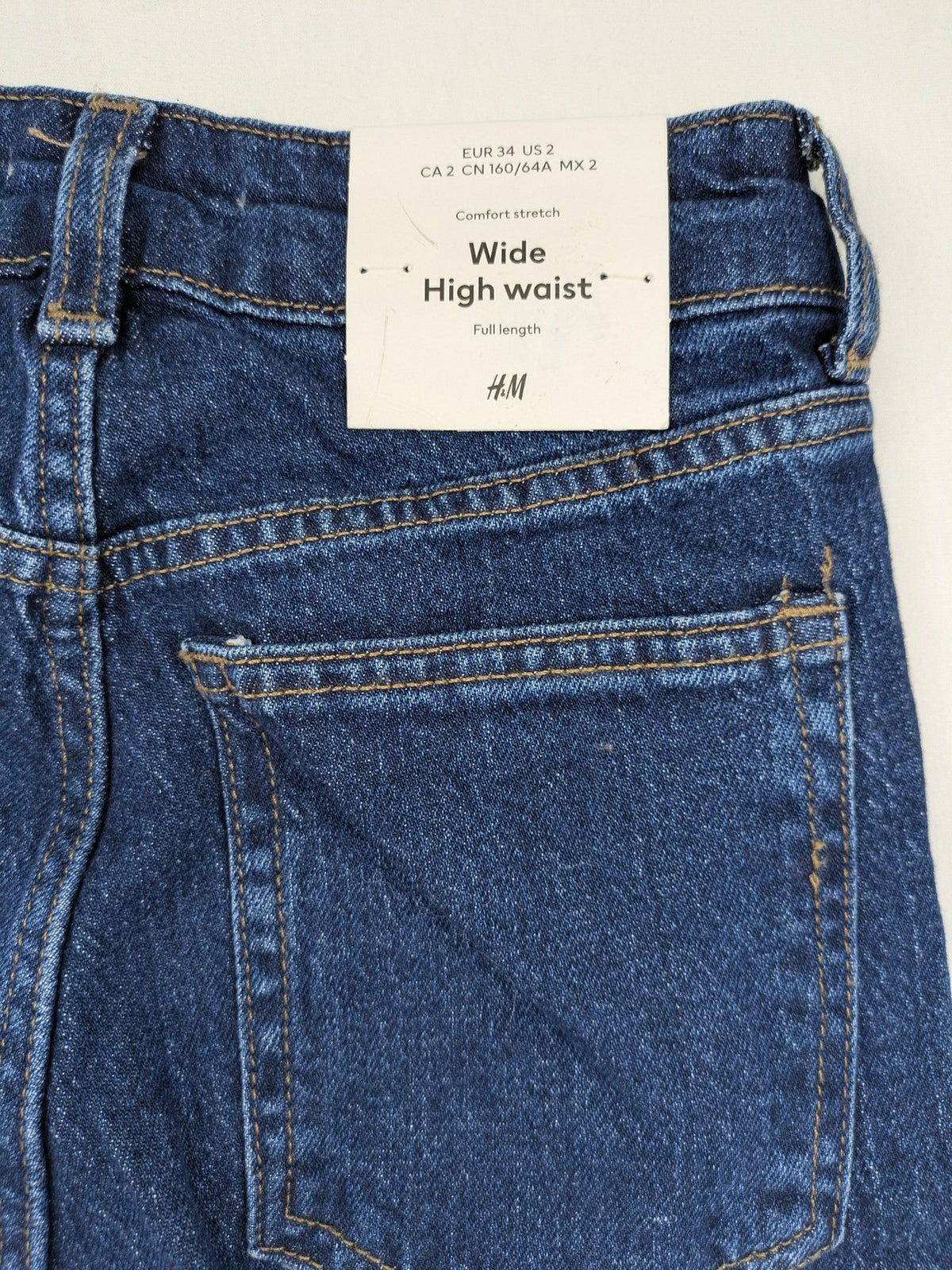 H&M blue wide leg high waist jeans with classic 5-pocket design and stretch denim.