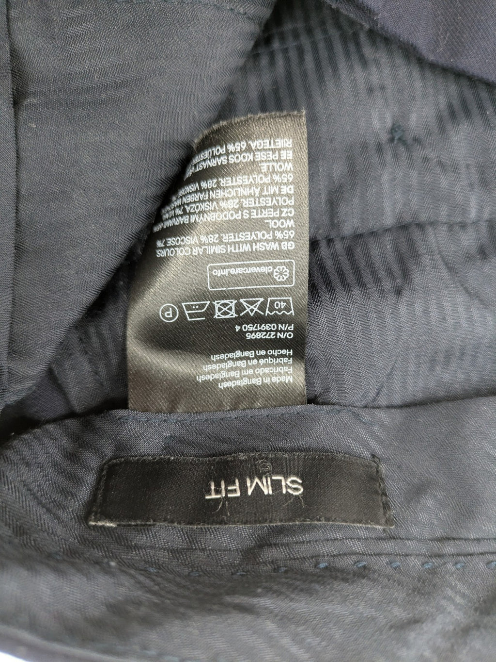 H&M navy slim fit executive suit trousers with flat-front design and side pockets.