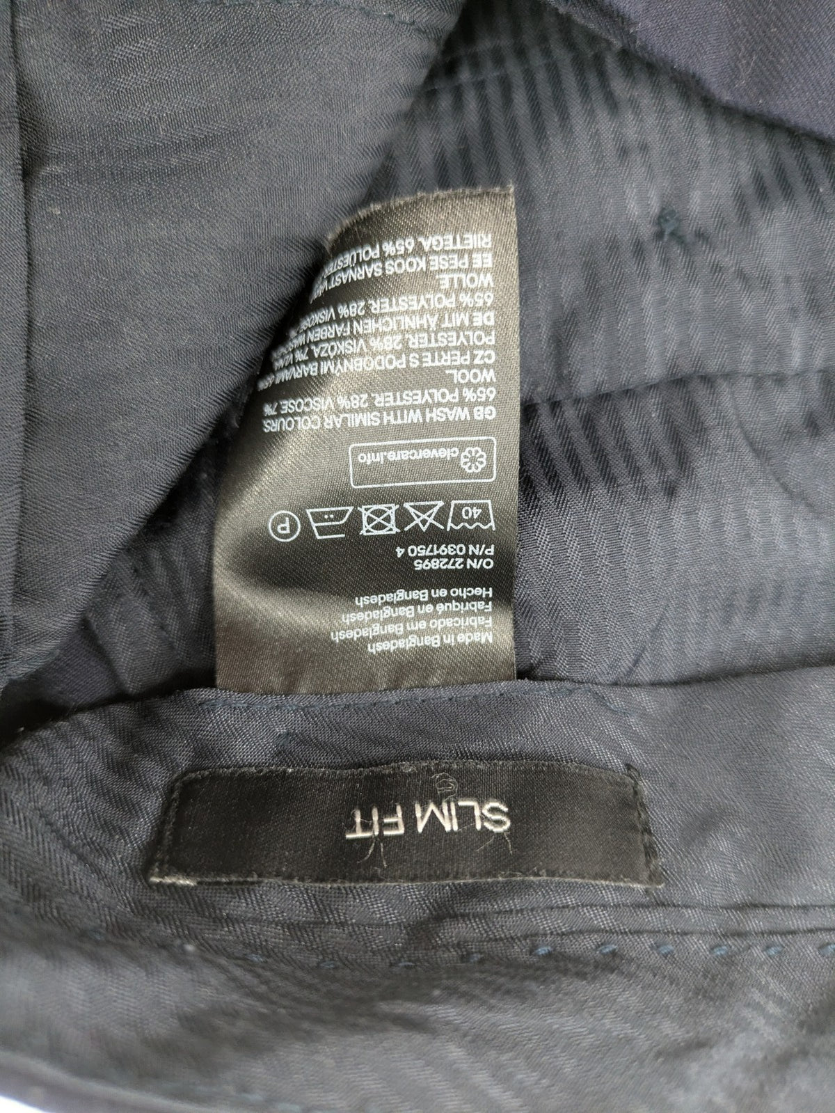 H&M navy slim fit executive suit trousers with flat-front design and side pockets.