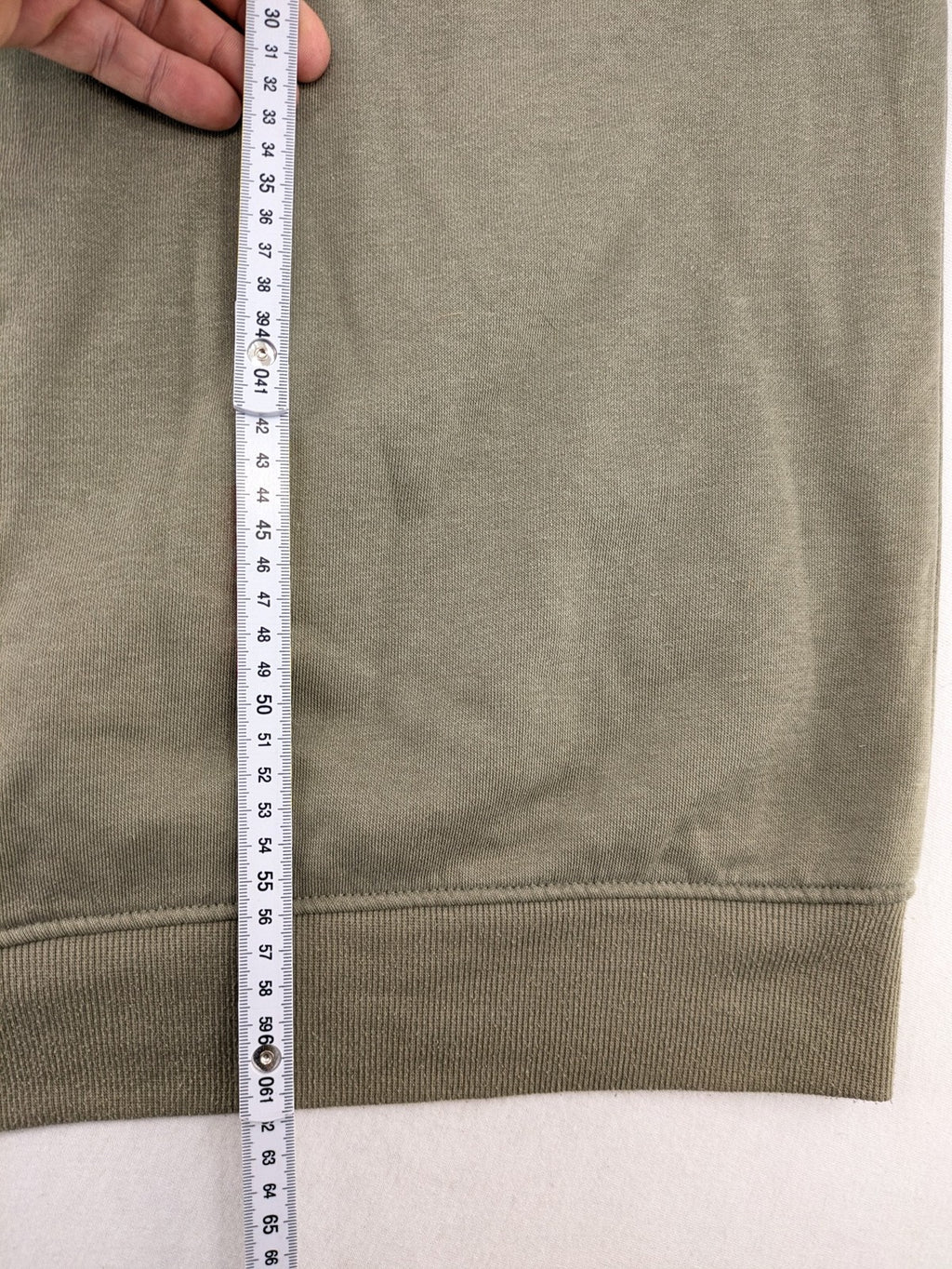 Naruto khaki turtle neck jumper featuring red Akatsuki cloud and Sharingan symbols.